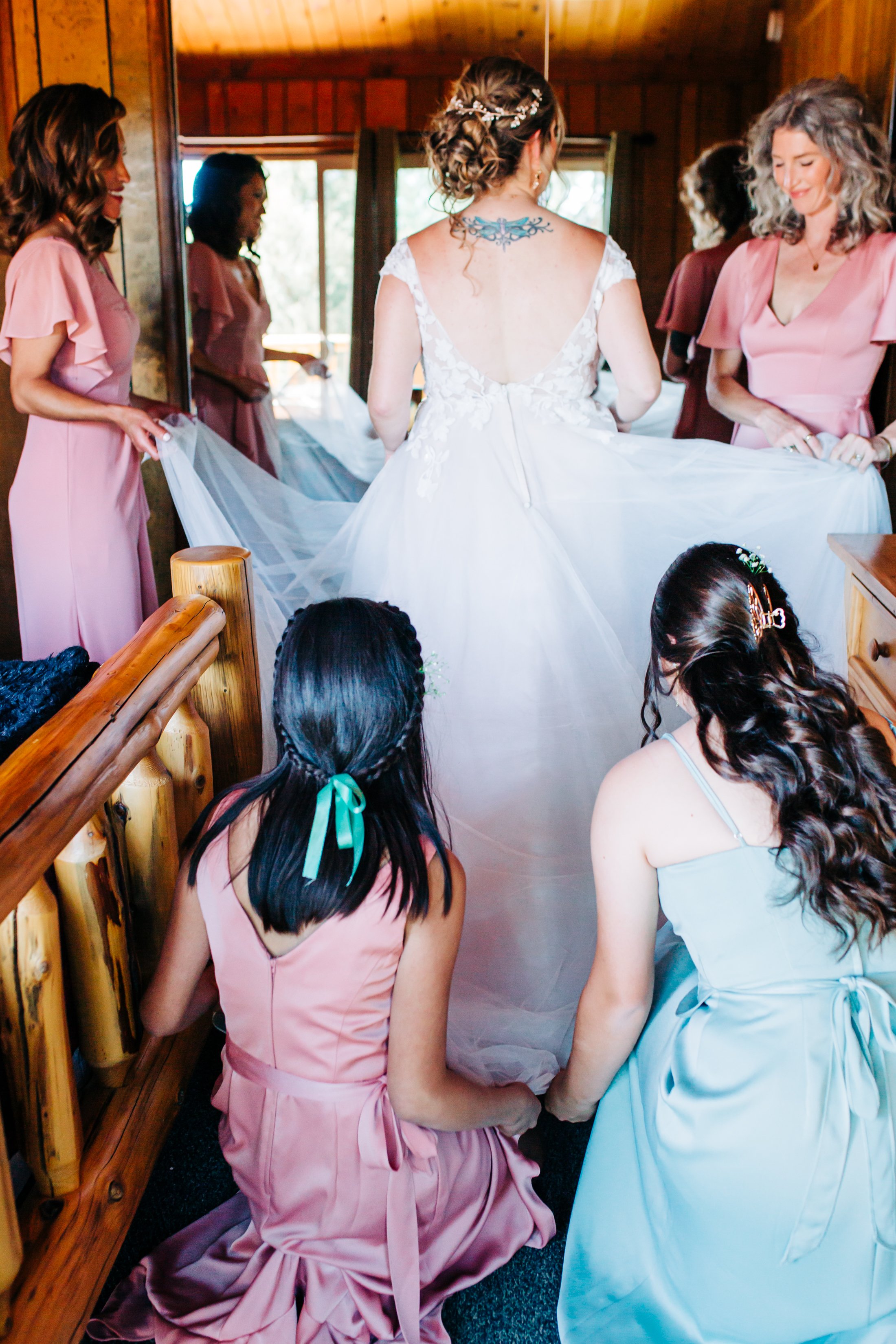 bridal party touching brides dress.jpg