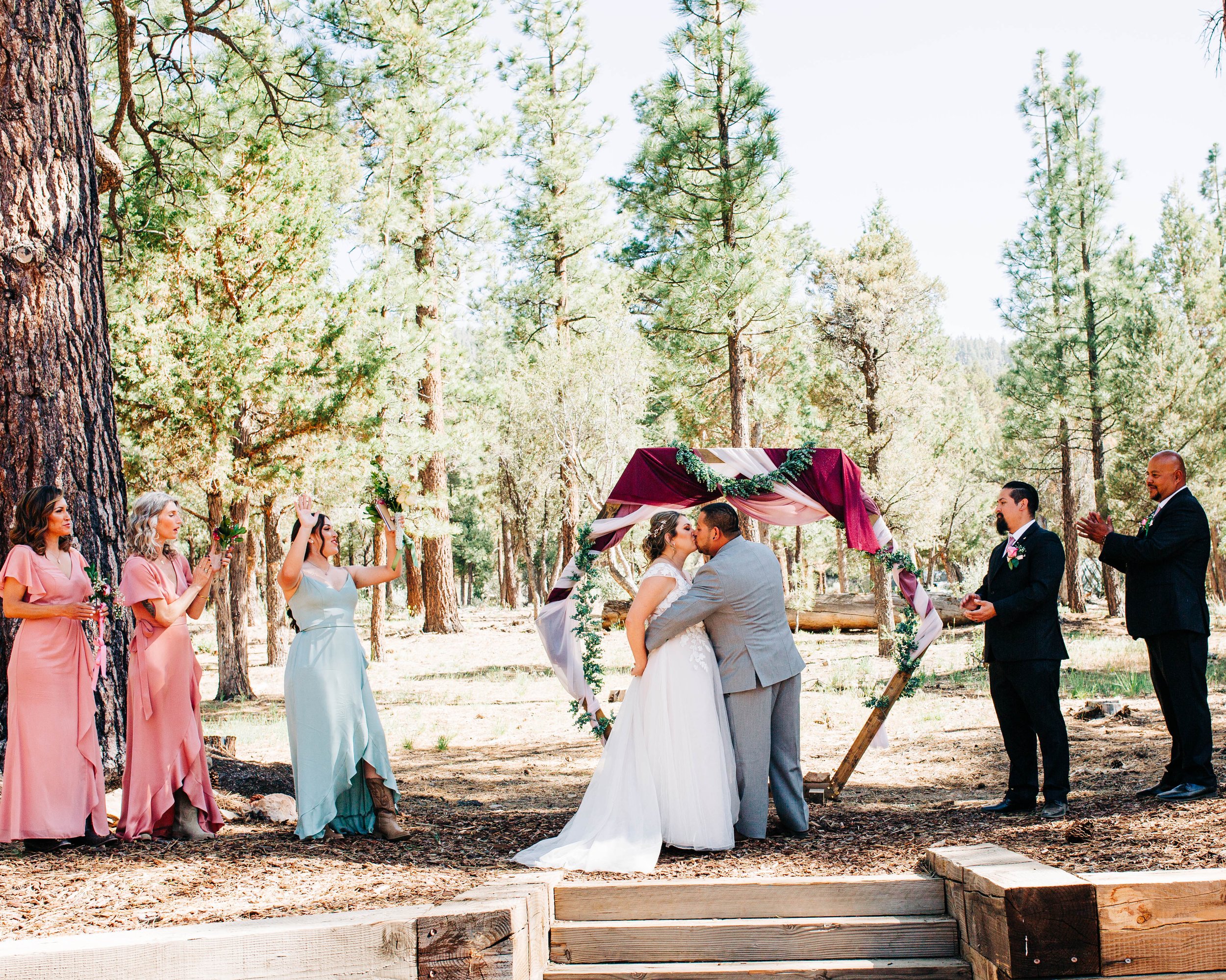 bride and groom kissing at wedding ceremony.jpg