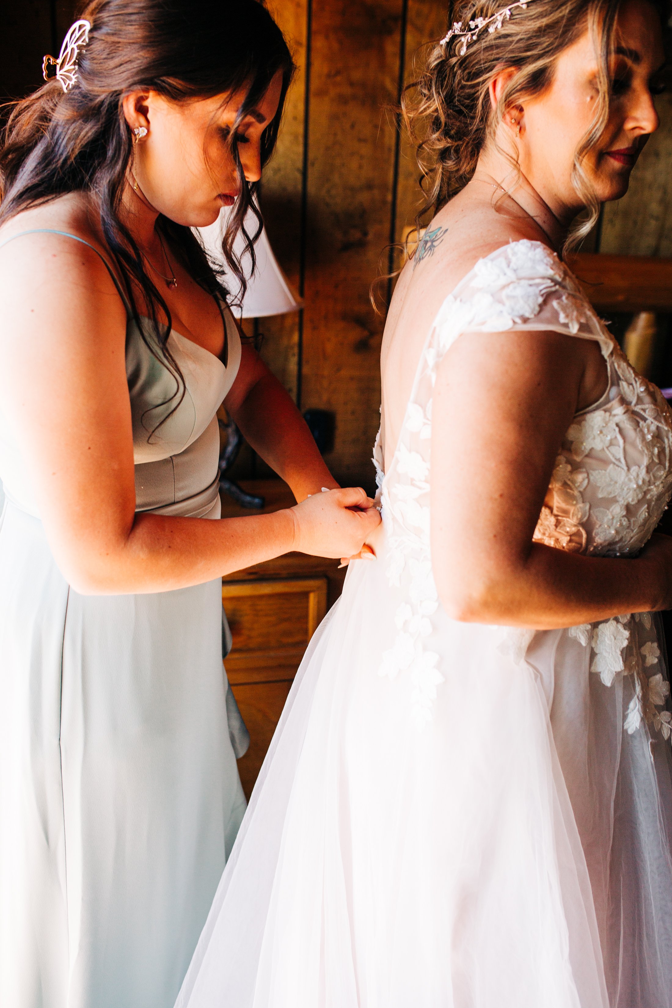 maid of honor zipping up brides dress.jpg