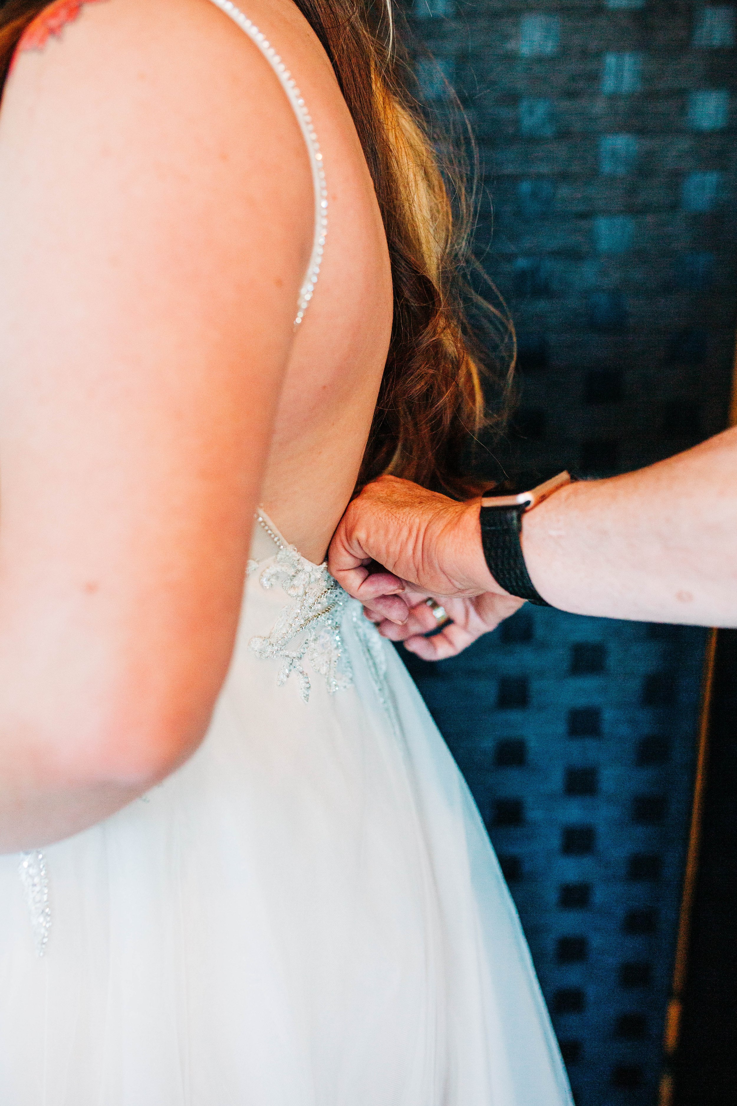 bride getting wedding dress zipped.jpg