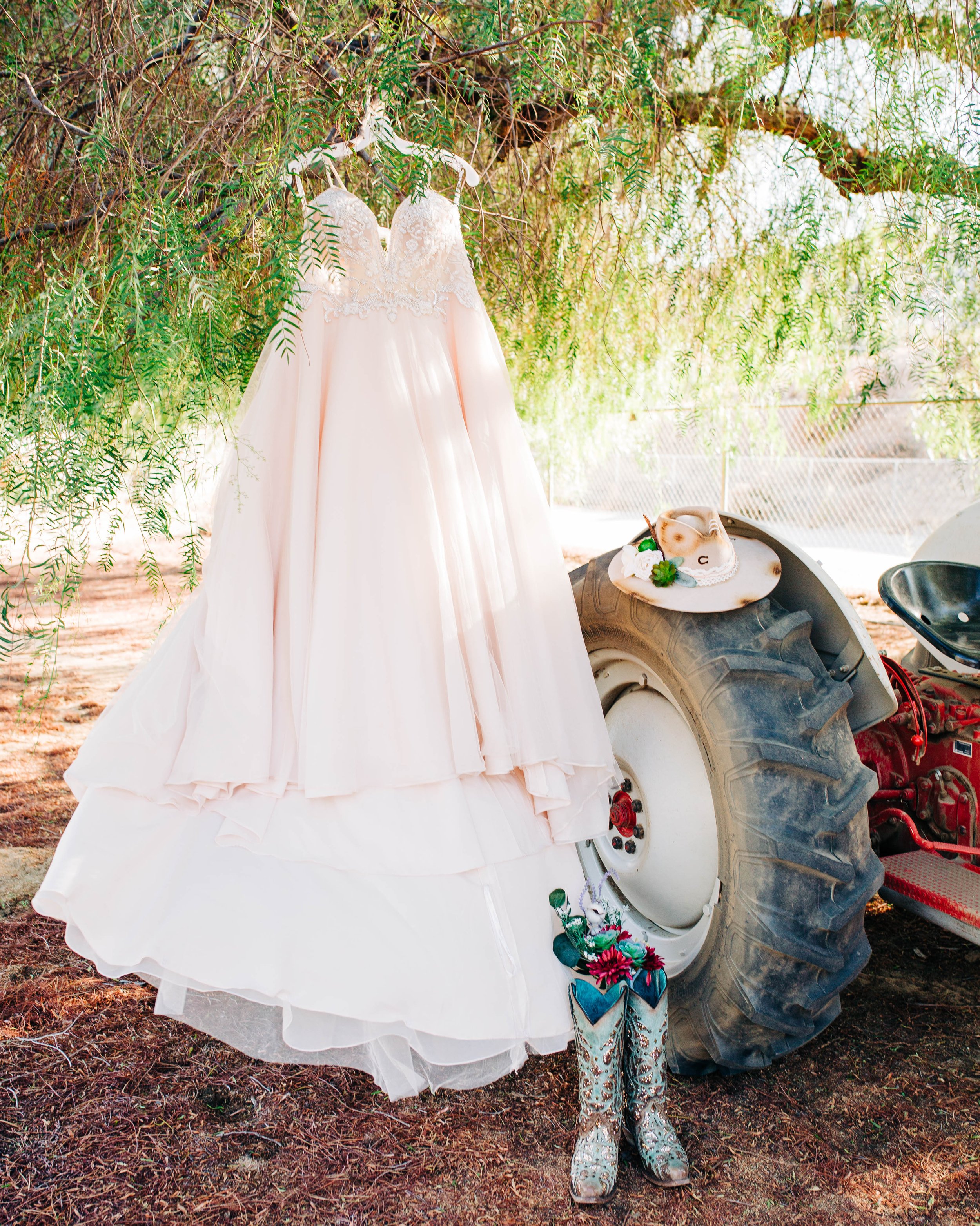 wedding dress and wedding boots on a tractor.jpg