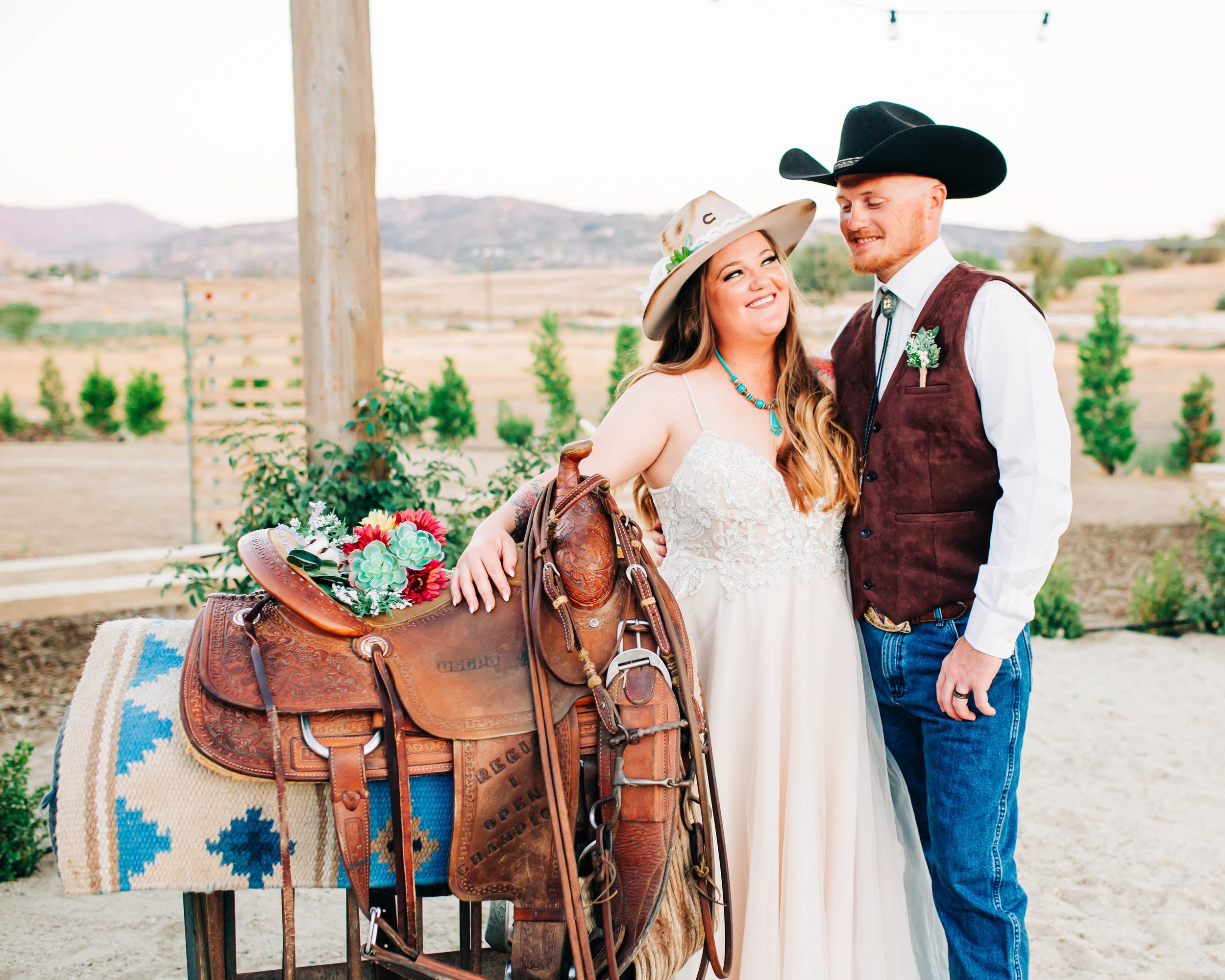 western bride and groom on saddle.jpg