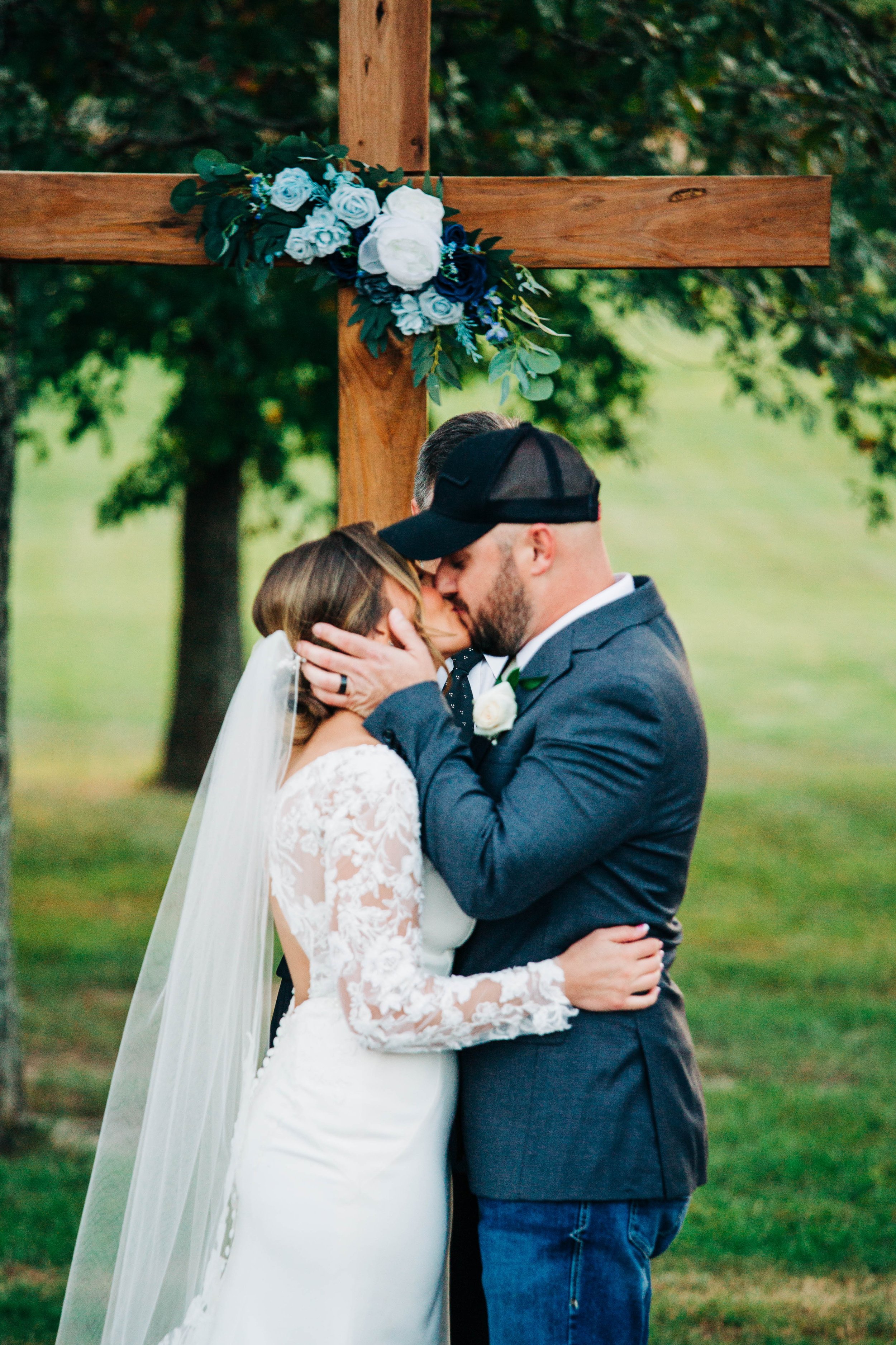 bride and groom kiss at cross.jpg