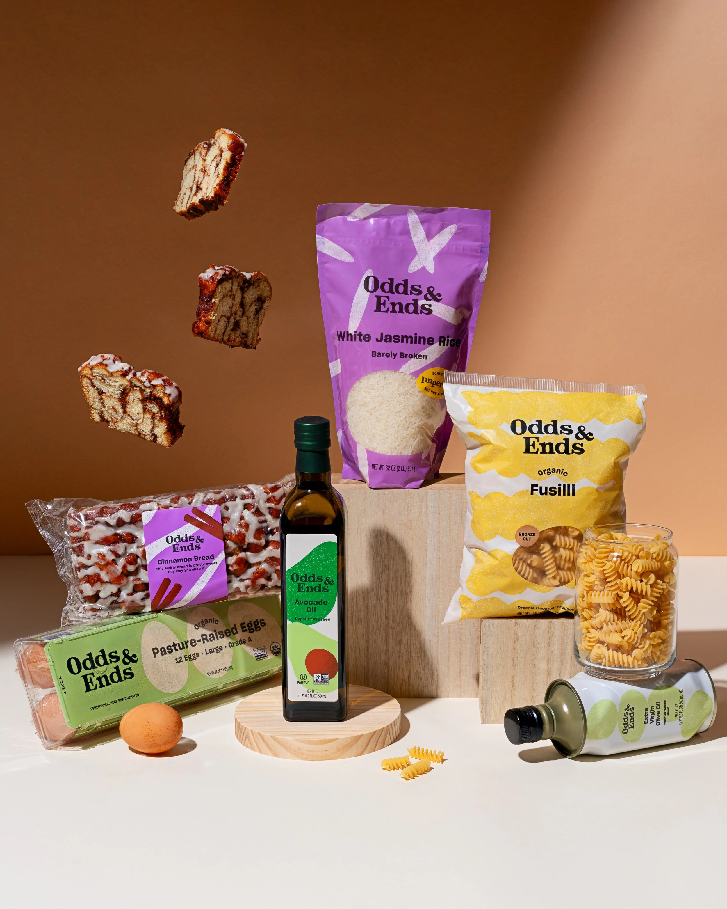 Assorted groceries including bread, pasta, eggs, avocado oil, rice, and snacks.