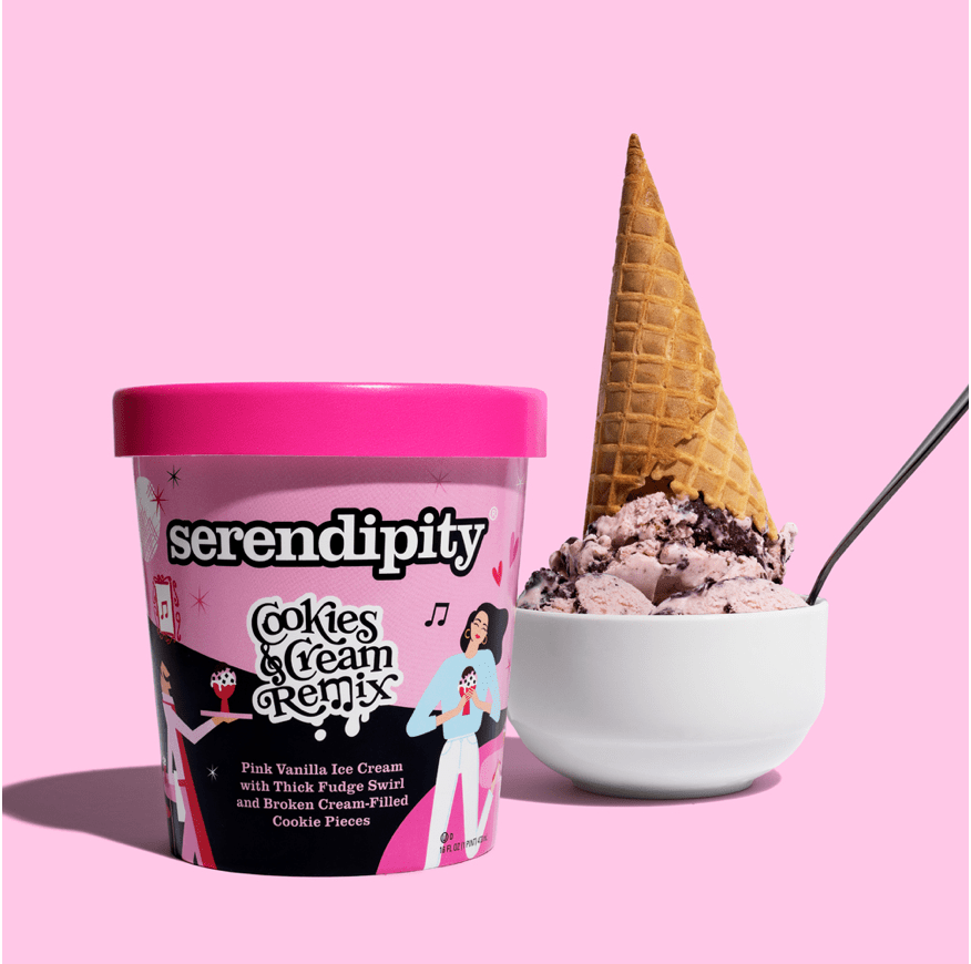 A container of Serendipity Cookies & Cream Remix ice cream next to a bowl of cookies and cream ice cream with an upside-down waffle cone on top, set against a pink background.