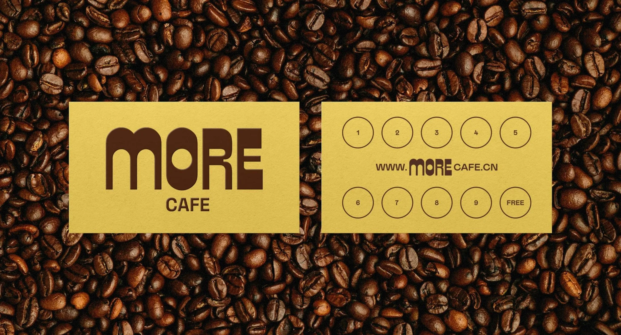 A promotional flyer for More Cafe, featuring a background of roasted coffee beans, with two beige rectangles overlaying the beans. The left rectangle displays the cafe's name in large dark brown letters, and the right rectangle contains a series of numbered circles, a website URL, and a small text indicating a free item.