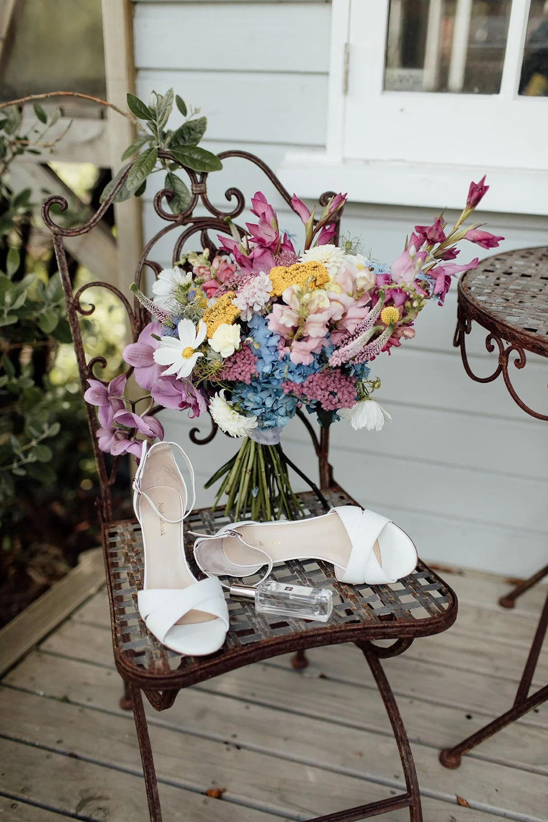 Colourful florals on a plinth at Pete & Kelsie's wedding at Mt Vernon Lodge, Akaroa