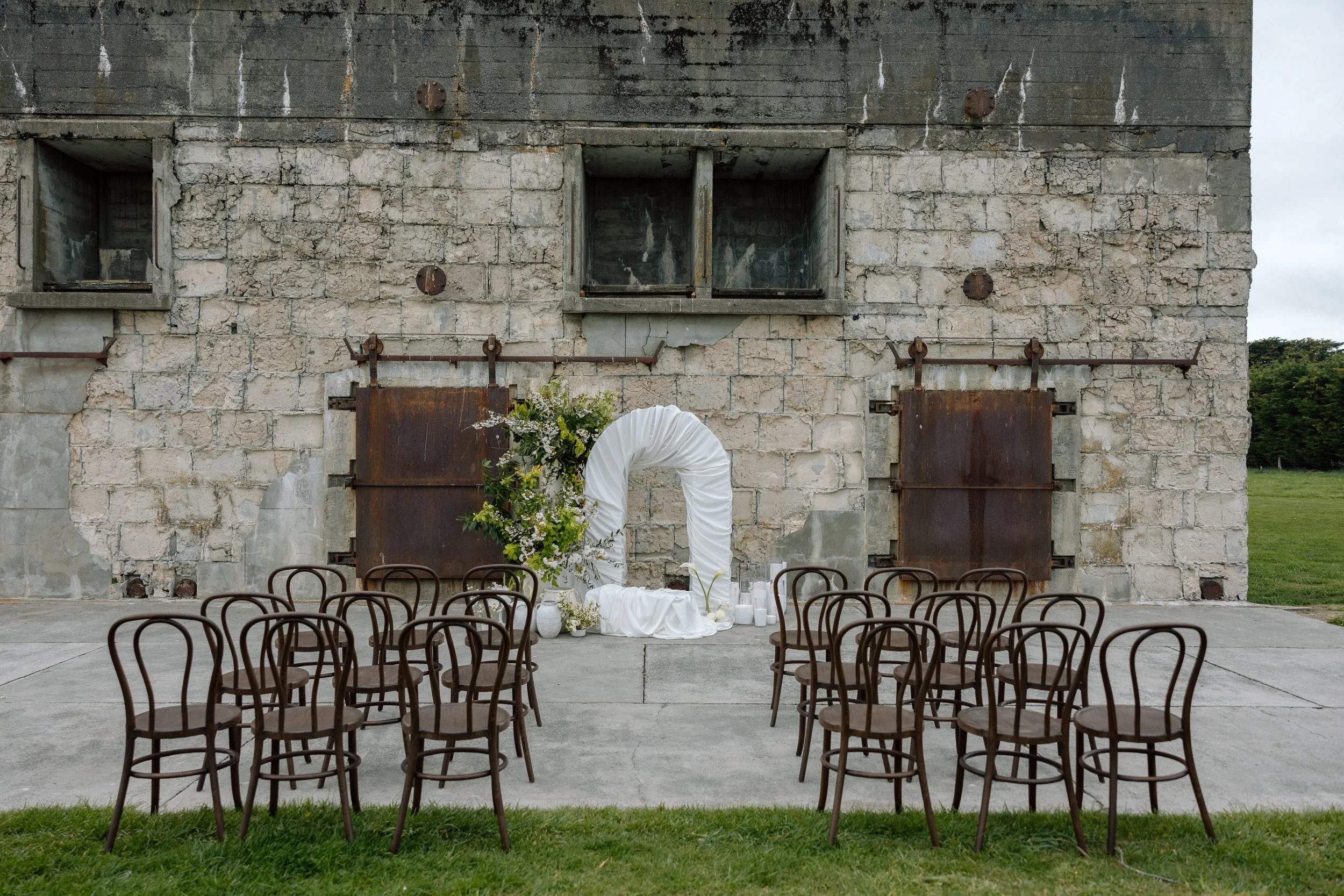 Walnut Bentwood chairs set in rows for an outdoor wedding ceremony – Loula Event Hire, Christchurch