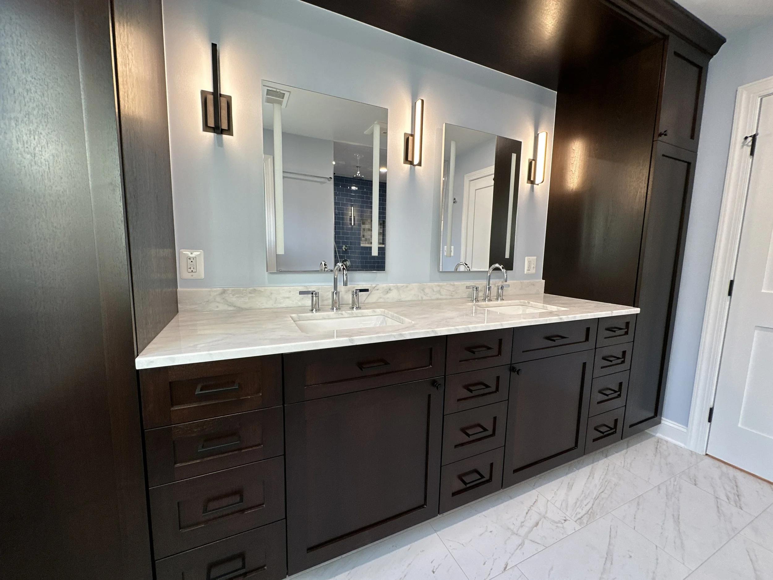 Bathroom with espresso wood double vanity, marble countertop, and rectangular mirrors in Arlington, VA