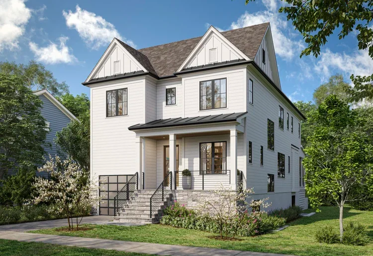 New Home: white two-story home in Arlington, VA, featuring a pitched roof, covered front porch with black railings, and a landscaped front yard surrounded by mature green trees in Arlington, VA