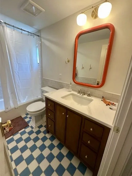 Bathroom with checkered floor and wood vanity in Arlington, VA