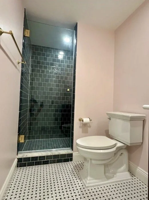 Walk-in shower with dark subway tile in Arlington, VA