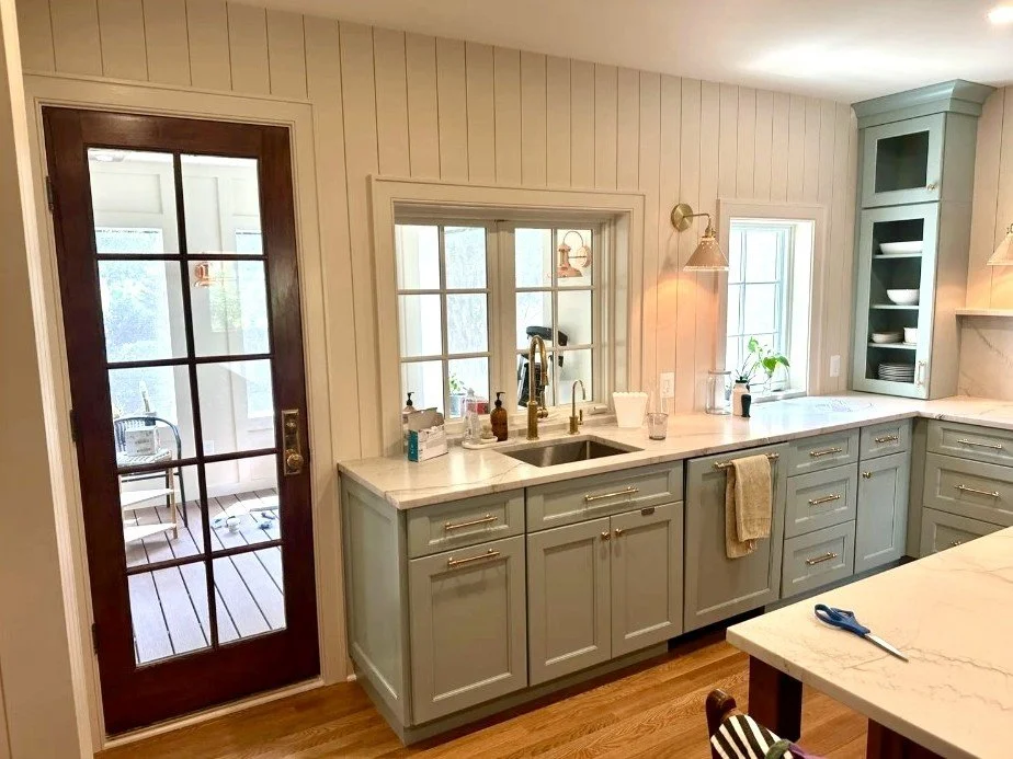 Kitchen with sage green cabinetry and shiplap walls in Arlington, VA