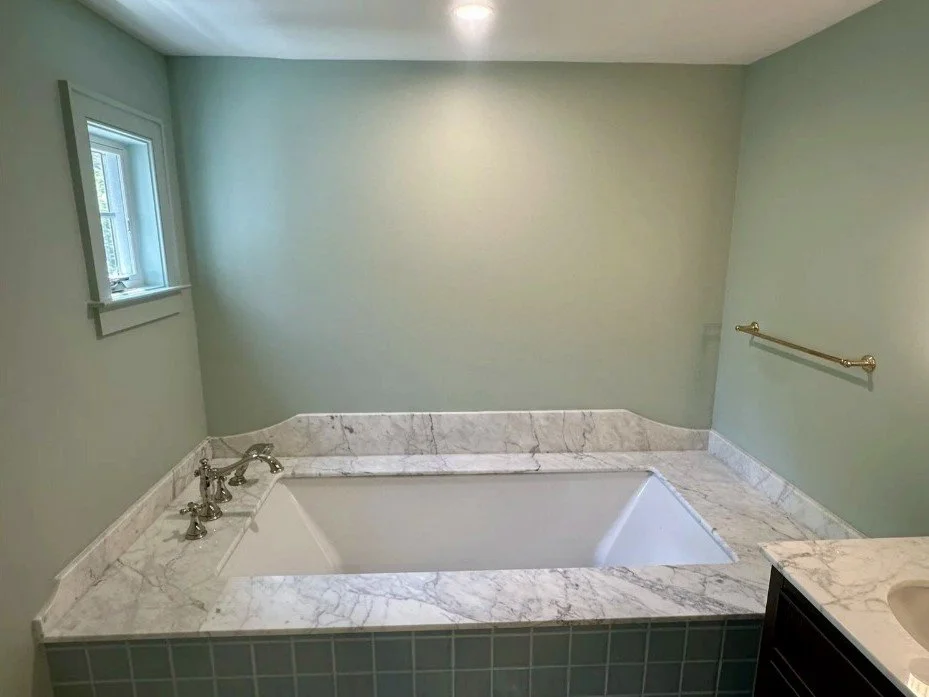 Corner soaking tub with stone surround in Arlington, VA