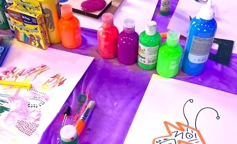 A person finger painting with bright colours
