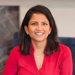 headshot of Priyanka Shinde, a woman wearing a red shirt smiling