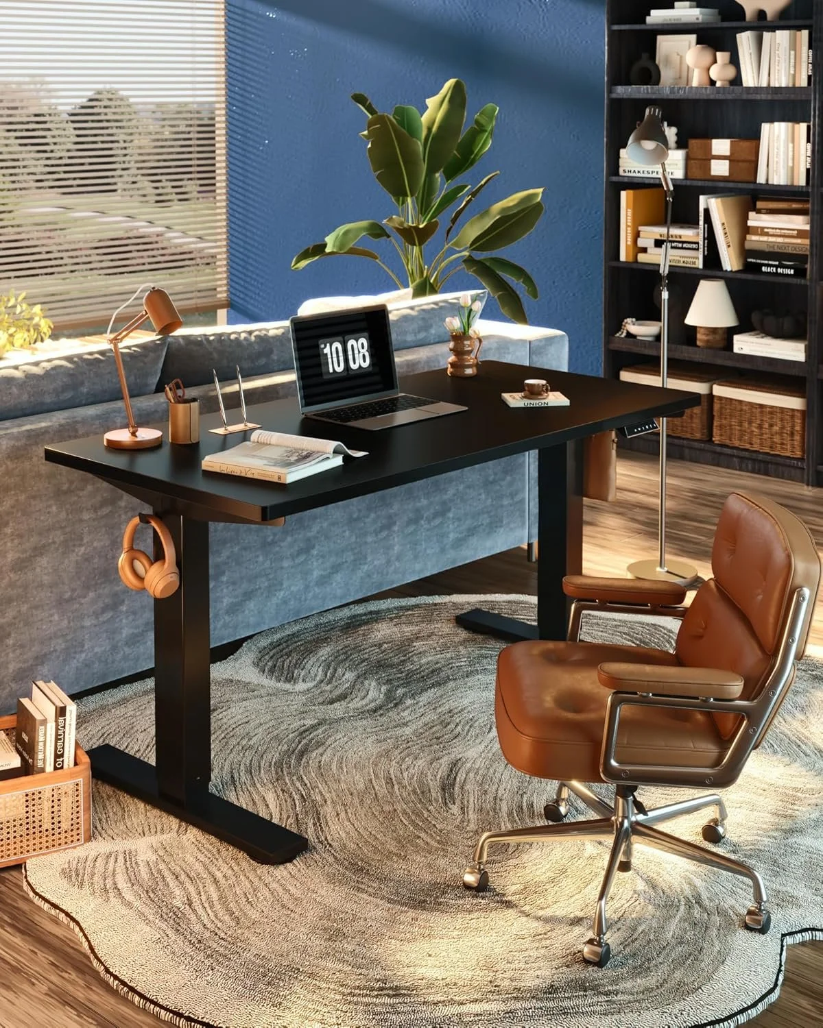 Desk set up featuring a black standing desk with a laptop and other office items on top, and brown leather rolling chair