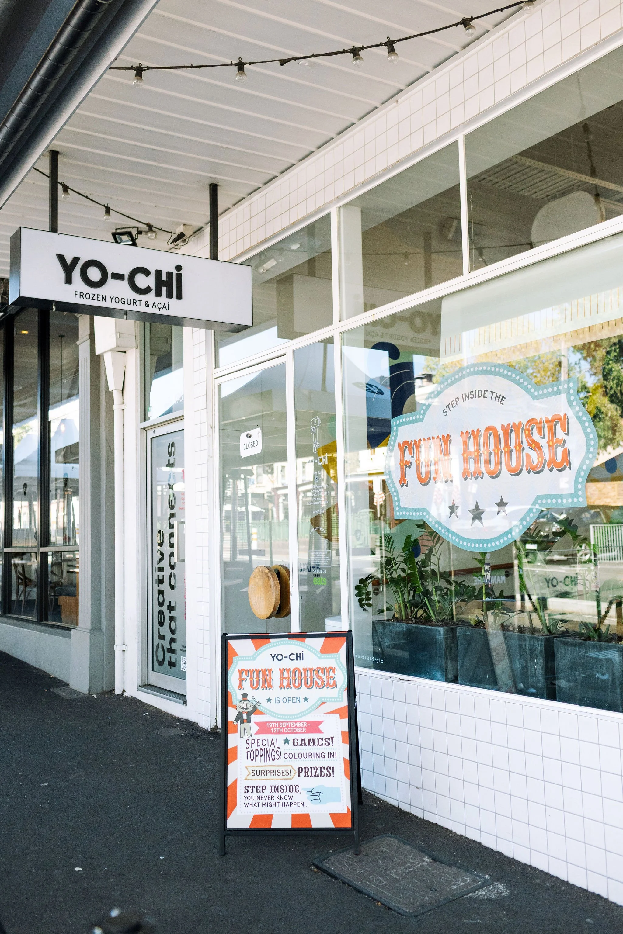 Yo-Chi entrance with Fun House branding on window and A-Frame