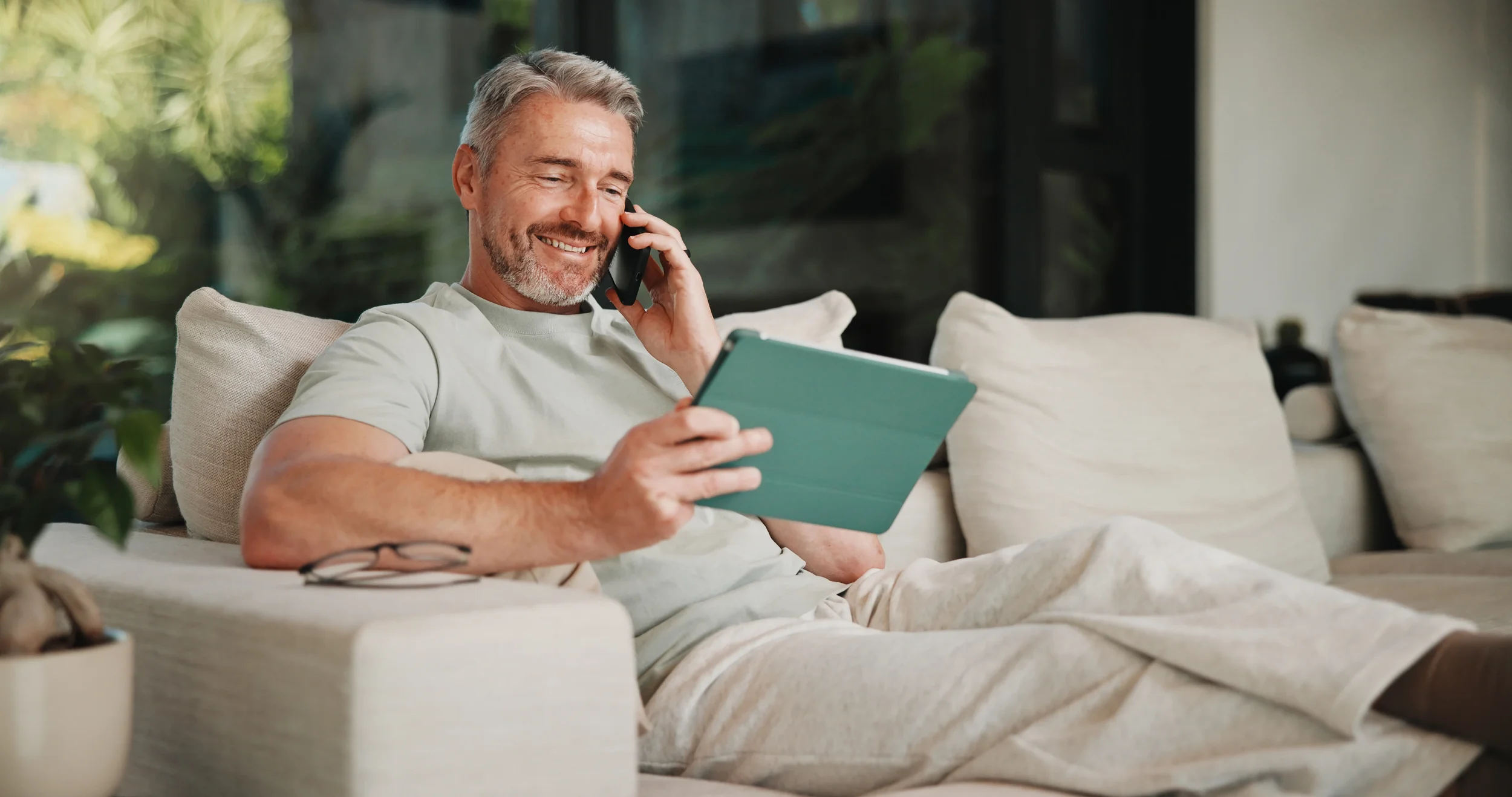 Relaxed man using an iPad while researching capital gains tax and negative gearing changes