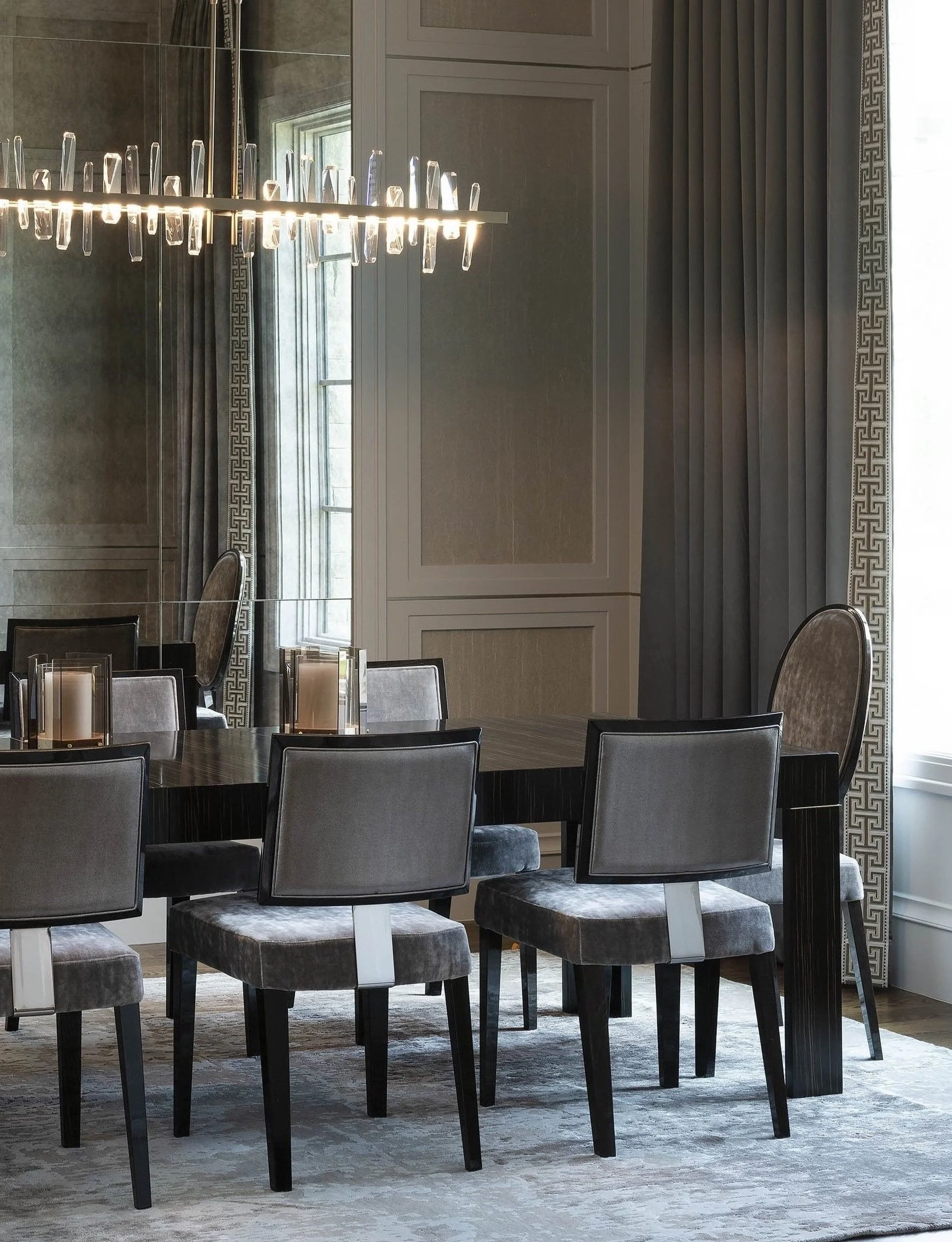 Luxury lives in the layers. 

A restrained palette gives way to rich materiality&mdash;textured wall covering, metal inlay, lacquered finishes, snakeskin leather, plush velvet, and ebony Macassar. Proof that a monochromatic room can still have plenty
