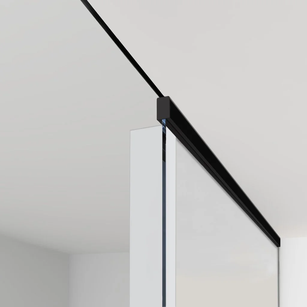 Close-up of a modern black ceiling rail and sliding door mechanism in a minimalist white room.