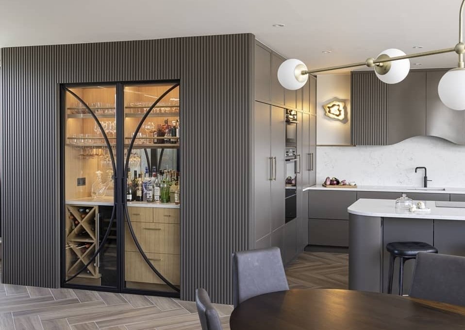 Drinks cabinate in living area separated by two steel glass sliding pocket doors