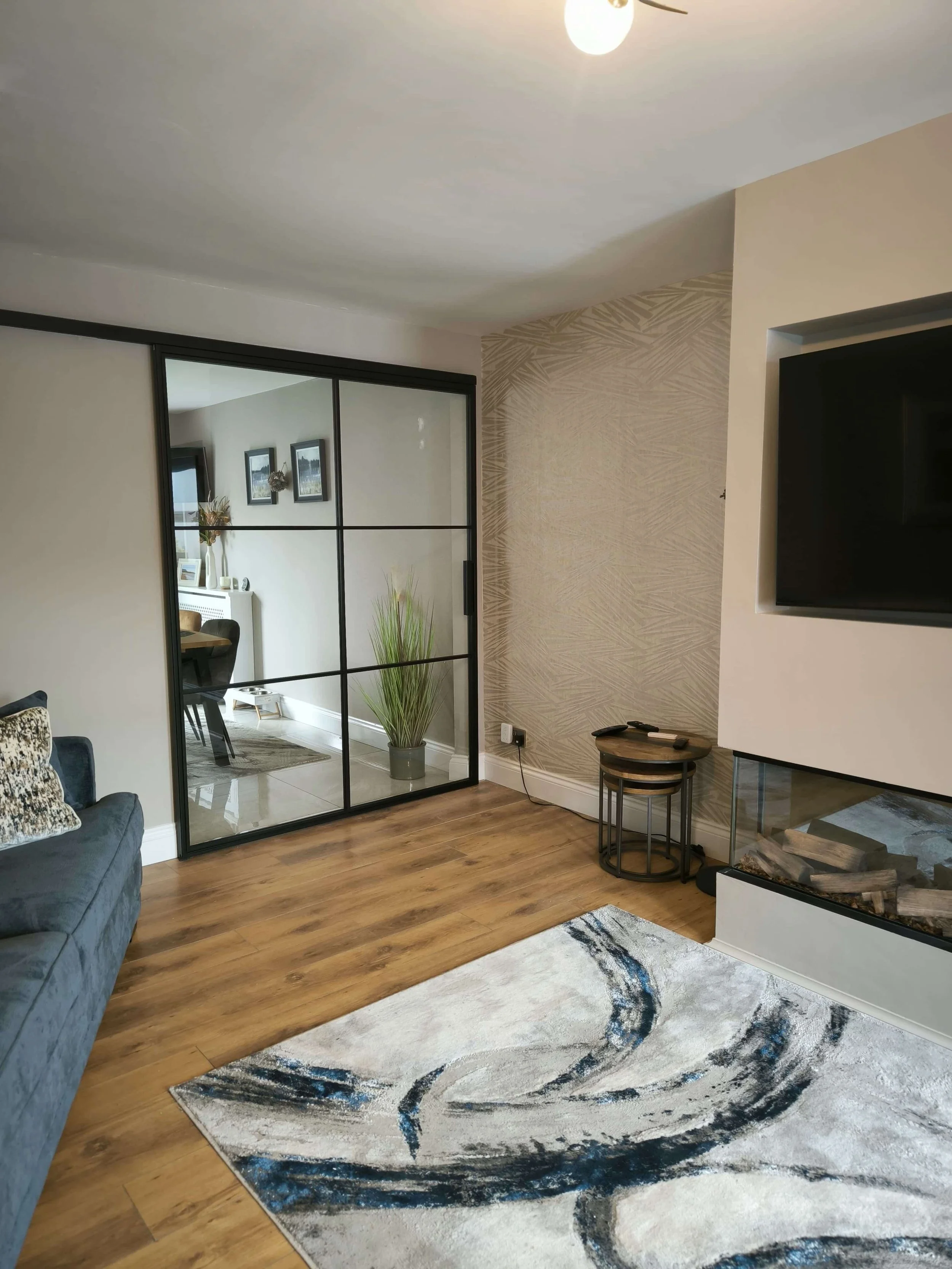 Modern sitting room with wall mounted black steel sliding door