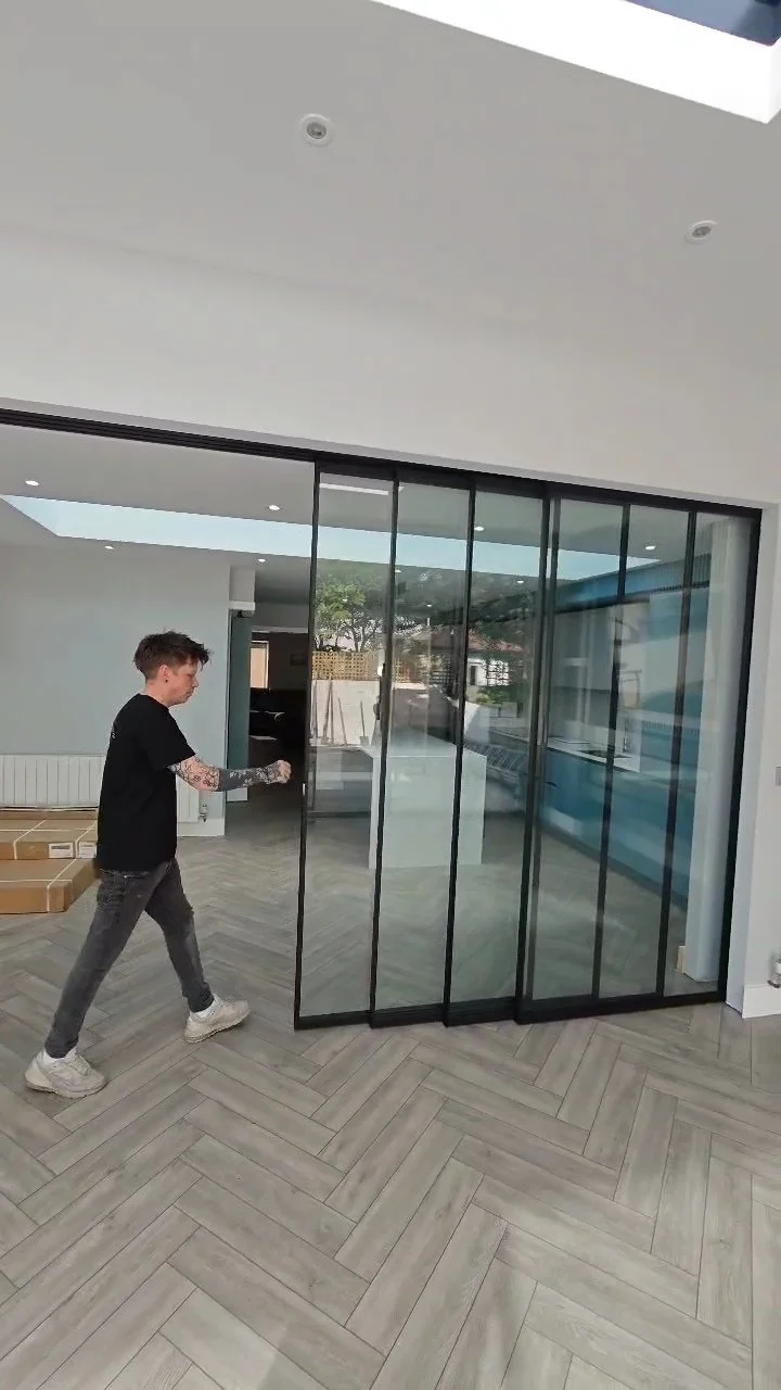 Glass sliding staching doors being pushed into pocket wall