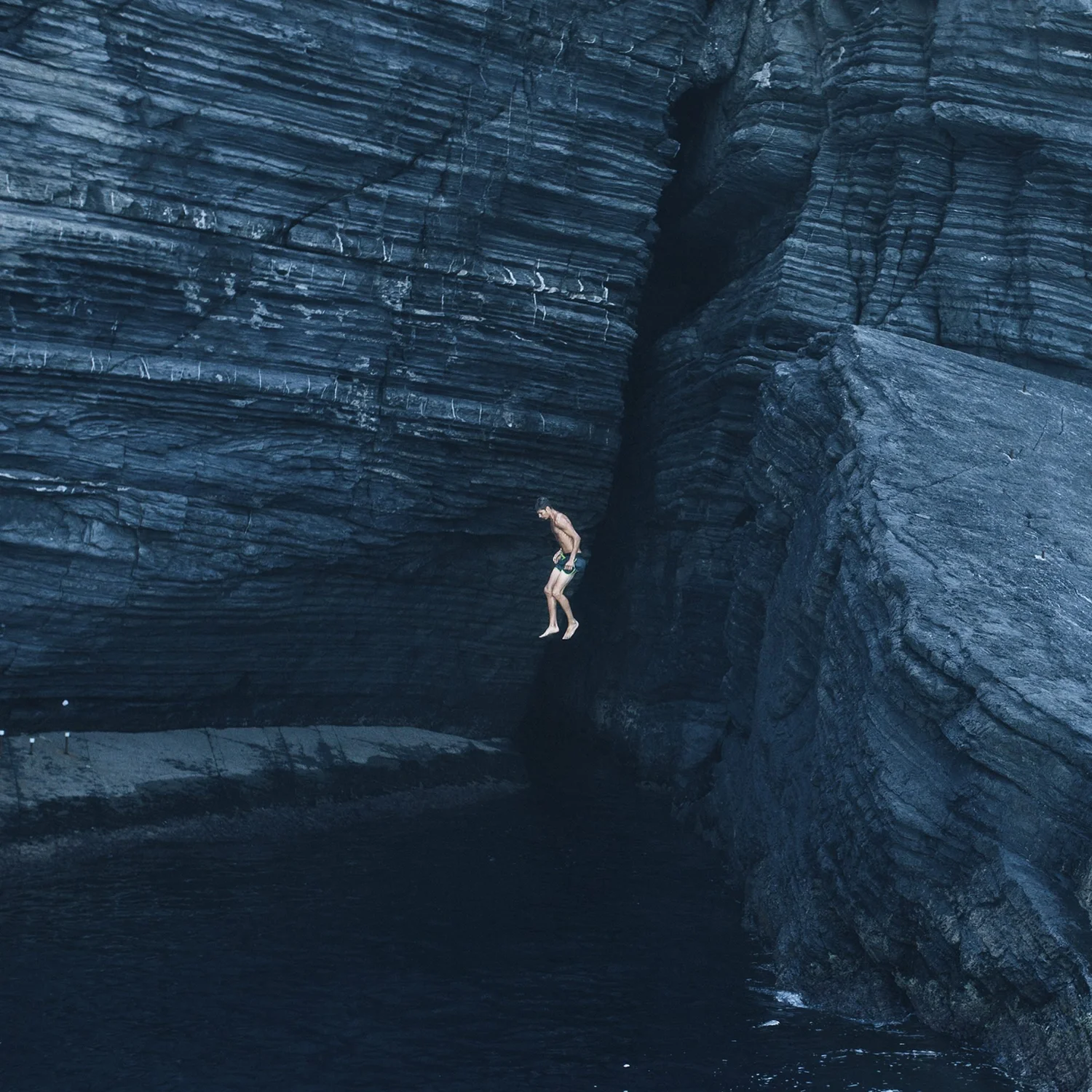 This Fragile World album cover: a boy jumping from a dark cliff into the sea