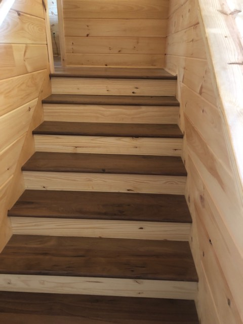 walnut stair trwads with white pine paneling.png