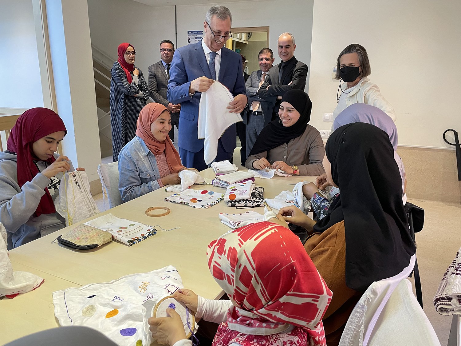 Appreciating the work of the group of 7 deaf and mute young women doing their apprenticeship in embroidery at Alnour