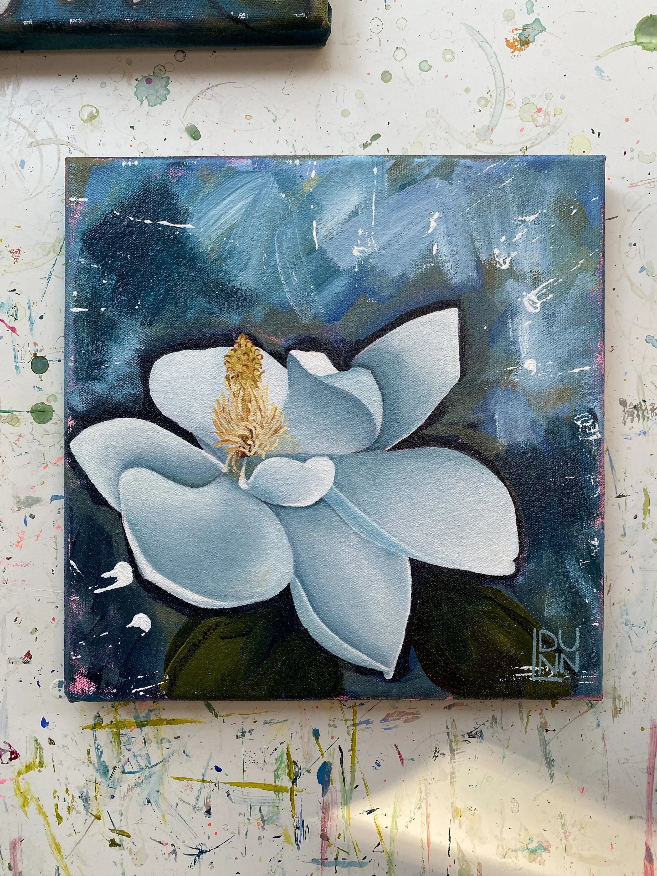 white magnolia bloom painting on abstract blue background