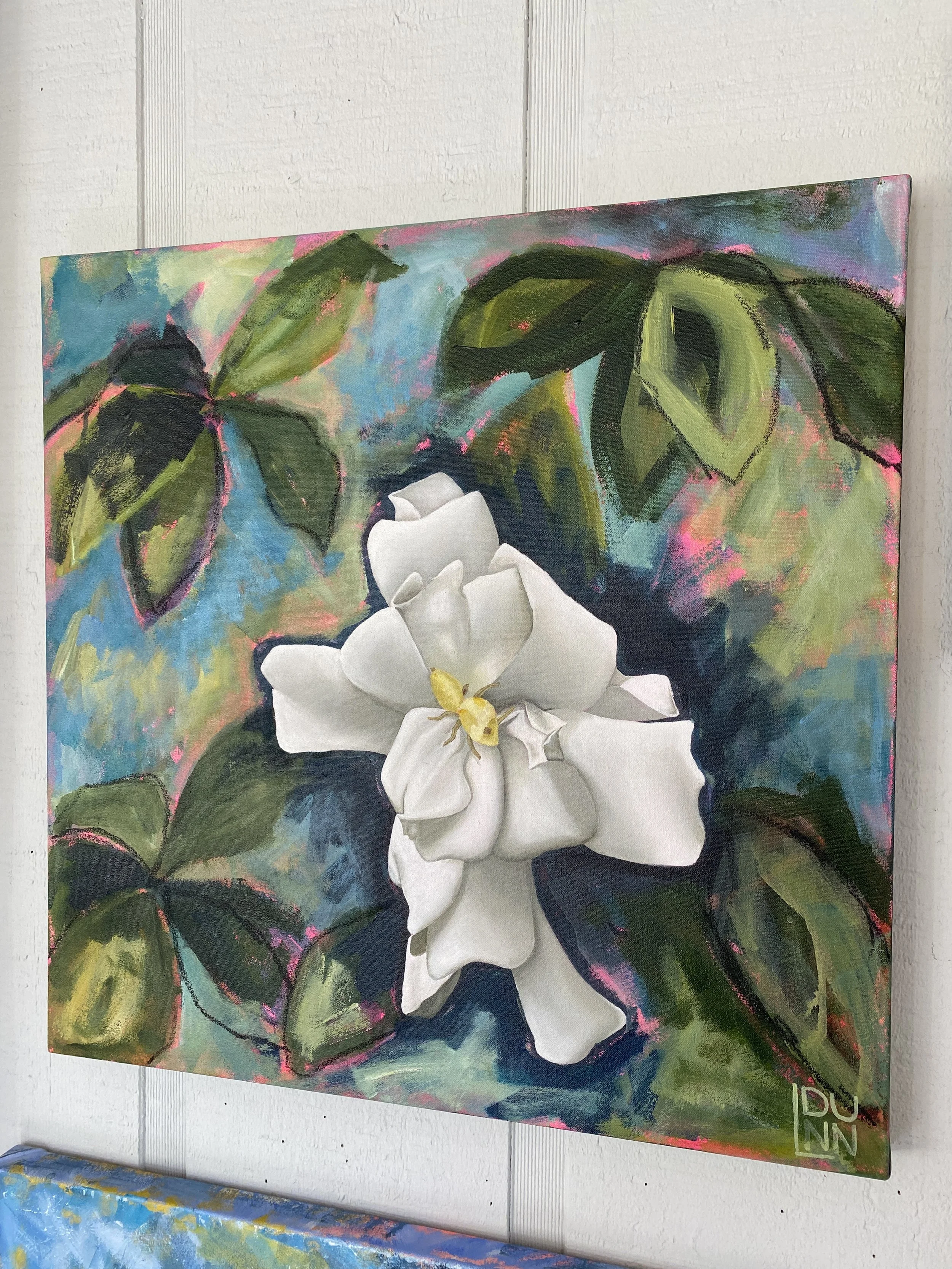 Gardenia bloom on abstract foliage background