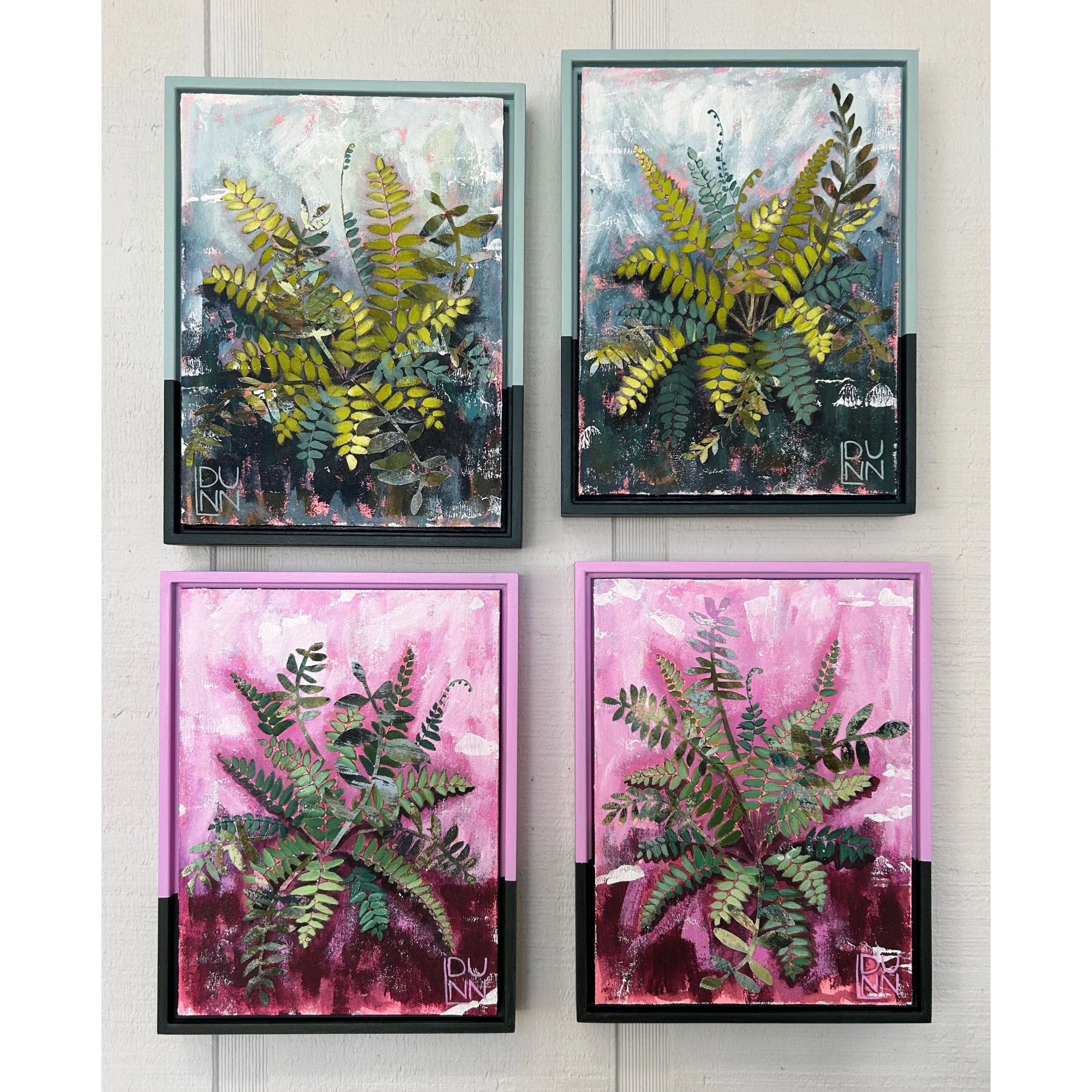 Four framed paintings of fern plants mounted on a wall in a 2x2 grid. The top two paintings feature fern leaves against abstract backgrounds with cool colors. The bottom two paintings feature fern leaves against pink and burgundy backgrounds.