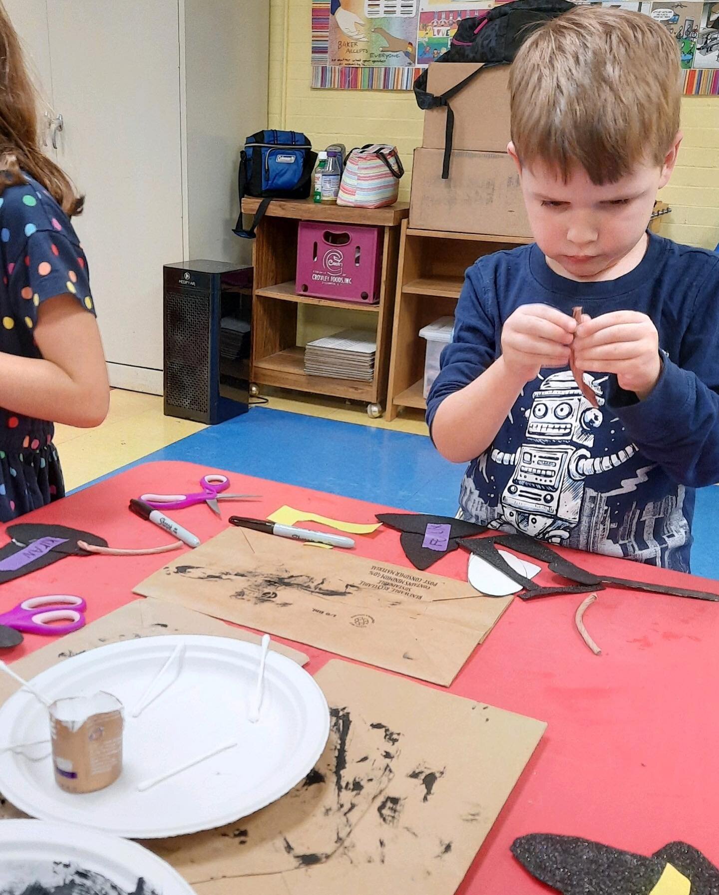 Kindergartner focusing hard on creating decorations for their Halloween bulletin board&hellip;swipe to see the end result!