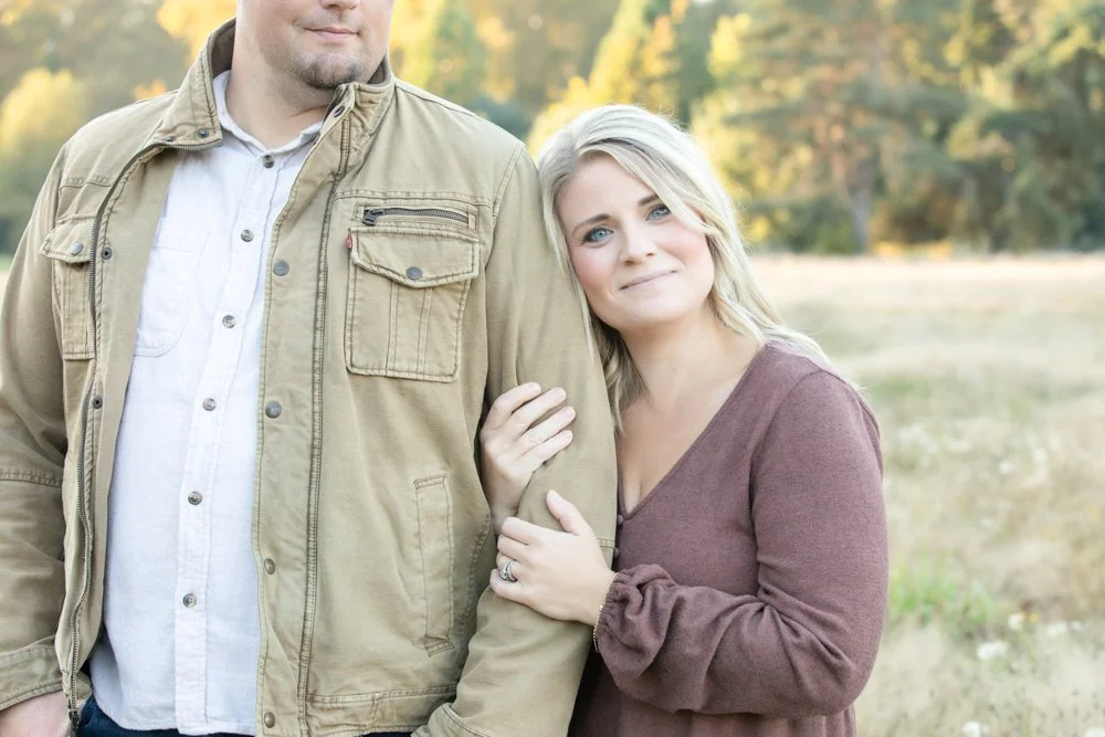 husband and wife standing in a field in field in Arlington Washington
