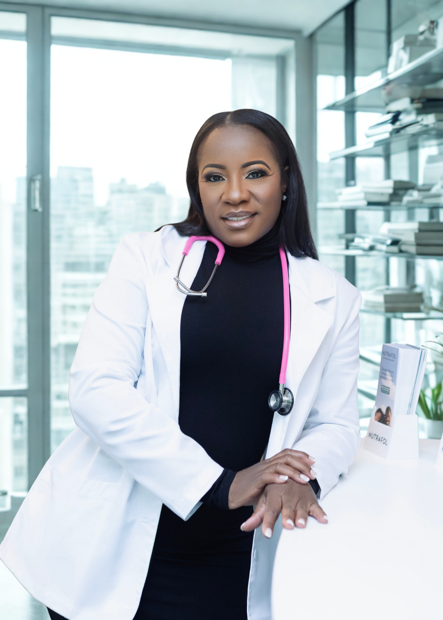 A female doctor with a stethoscope around her neck standing in a modern office with large windows and bookshelves.