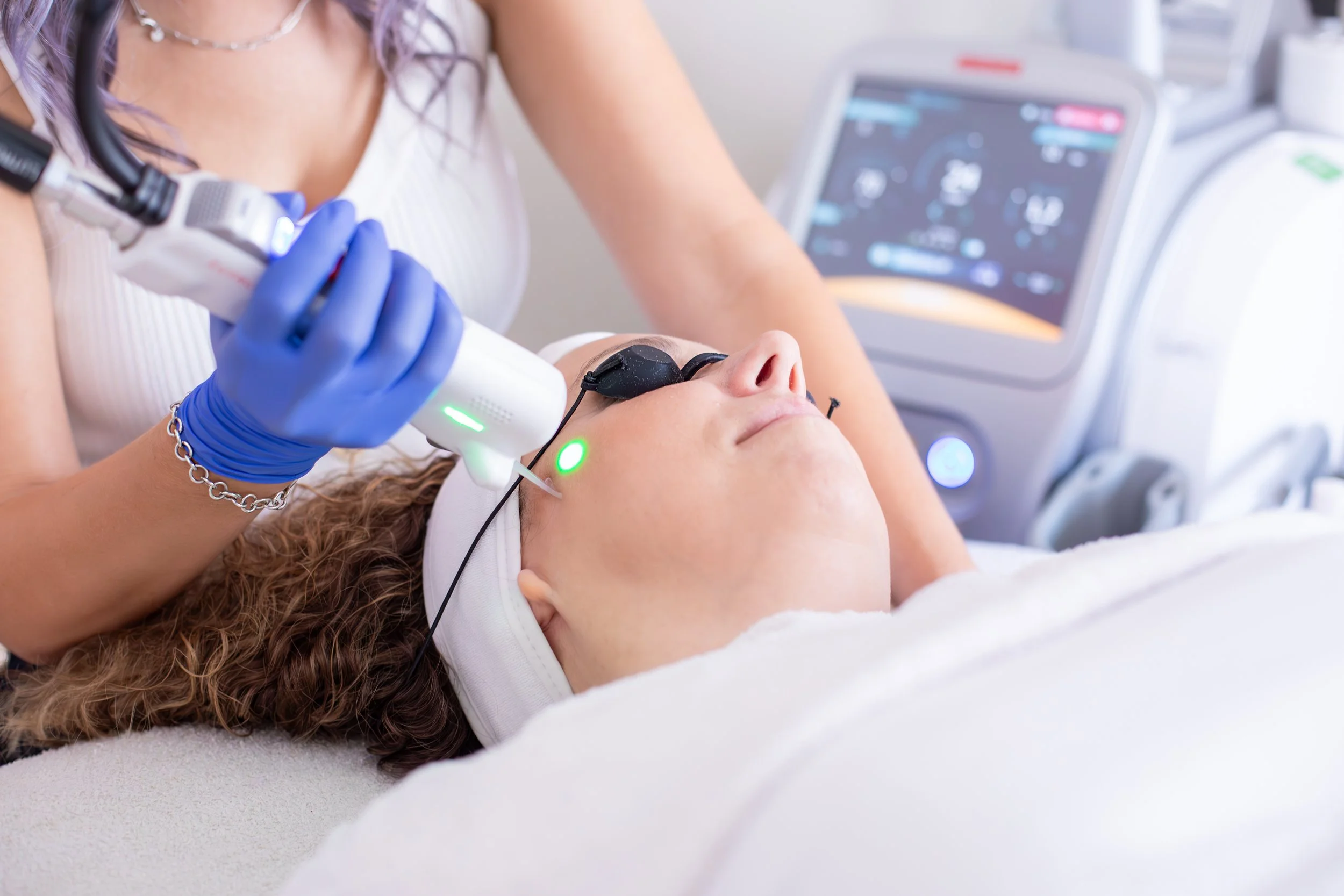 medical aesthetician preforming laser treatment
