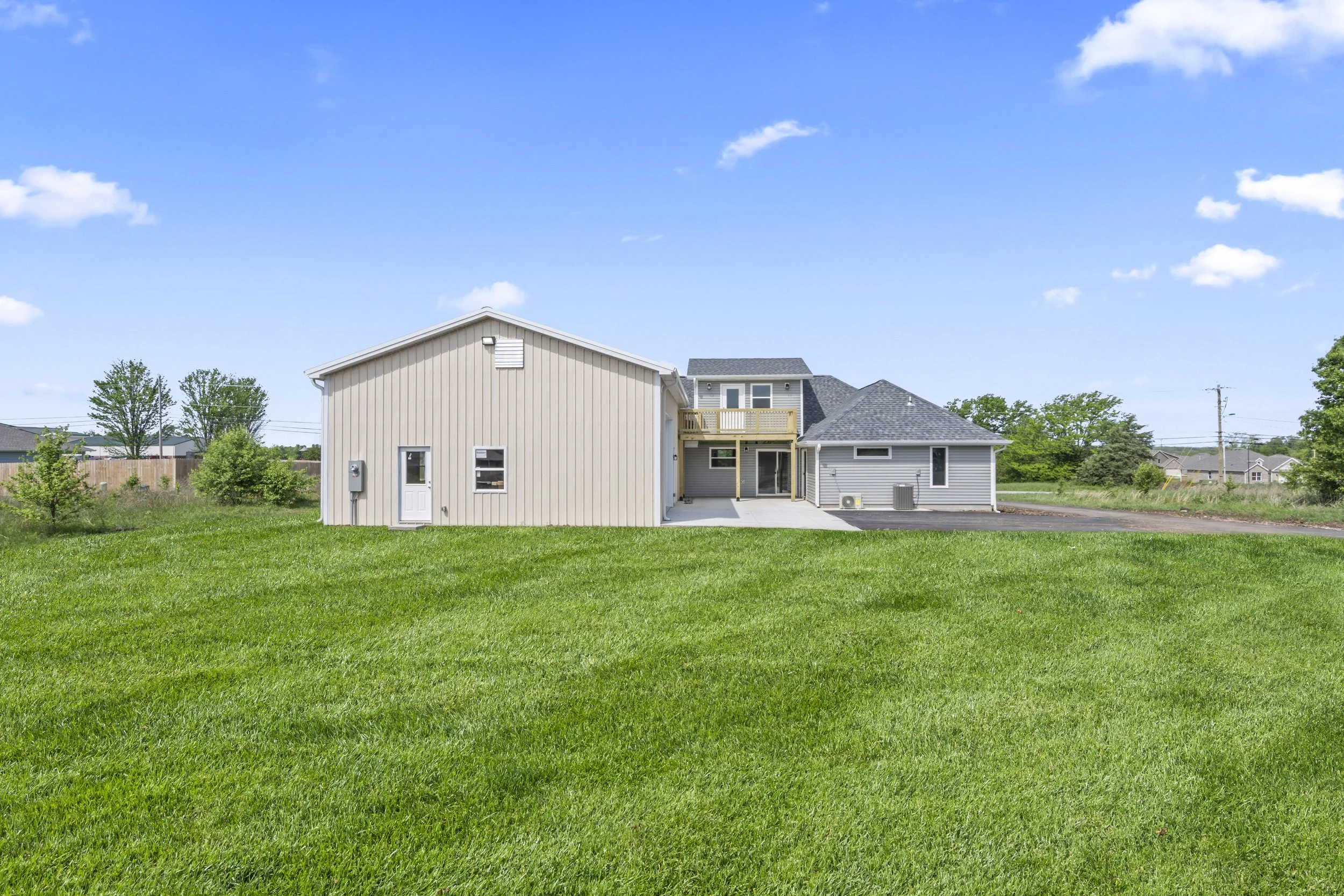 Modern custom home exterior featuring covered patio and spacious yard