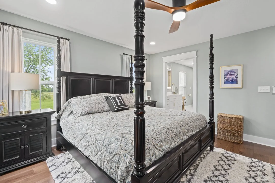 Spacious primary suite with custom finishes, natural light, and elegant design in a luxury custom-built home.