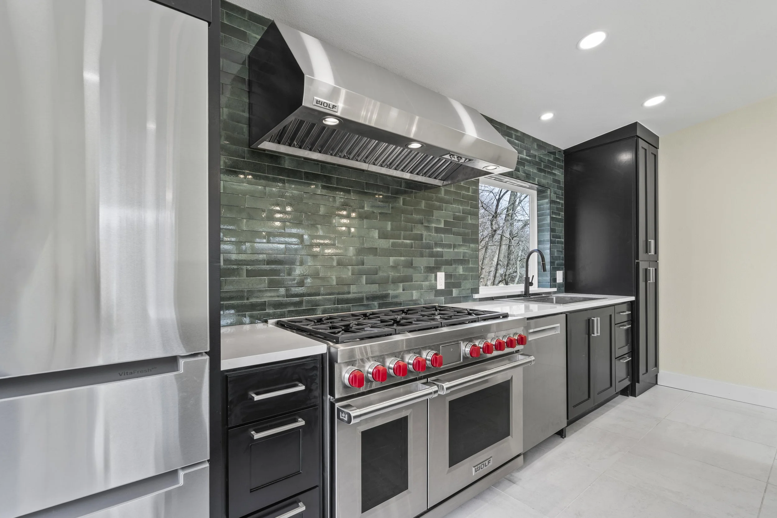 Luxury custom kitchen with commercial range and custom cabinetry built by Ahrenholtz Custom Homes in Northwest Arkansas