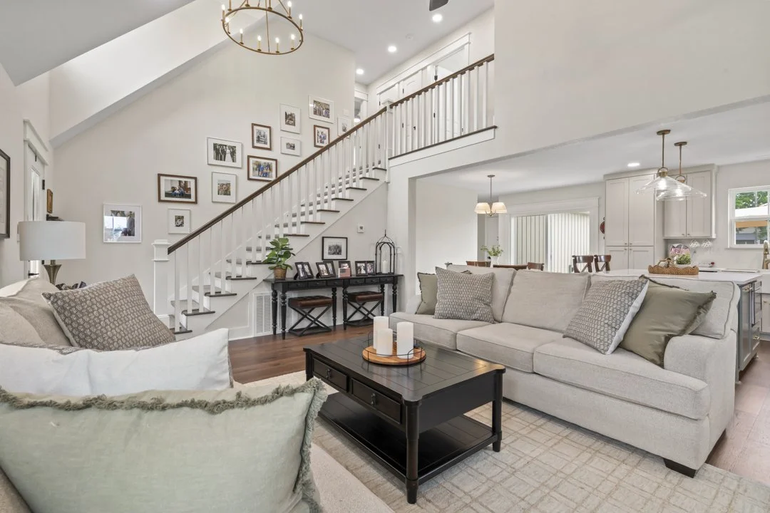 Custom home interior featuring vaulted ceilings, open staircase, and high-end craftsmanship throughout this Siloam Springs residence.