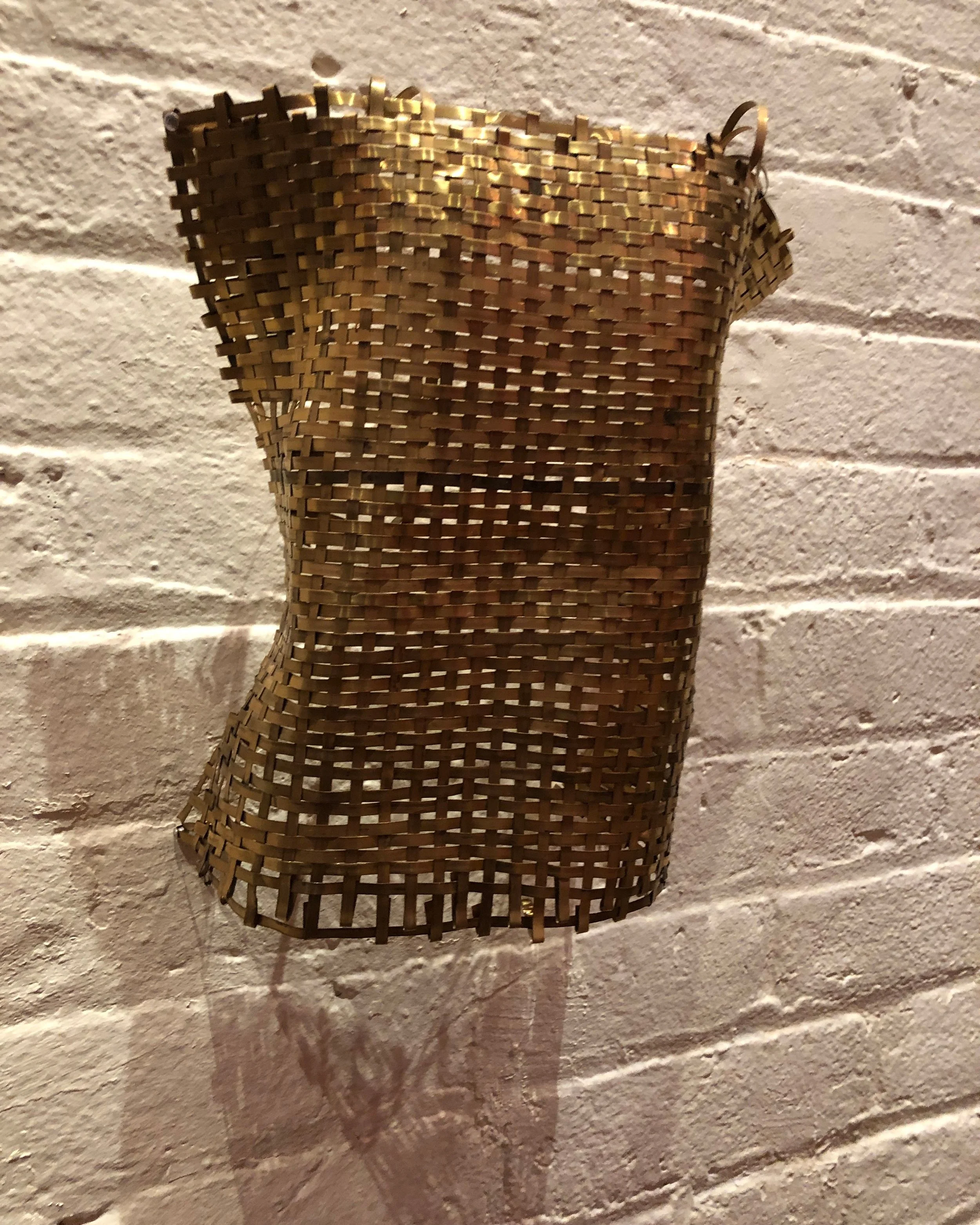 Toddler Breastplate, (on wall) woven brass strip