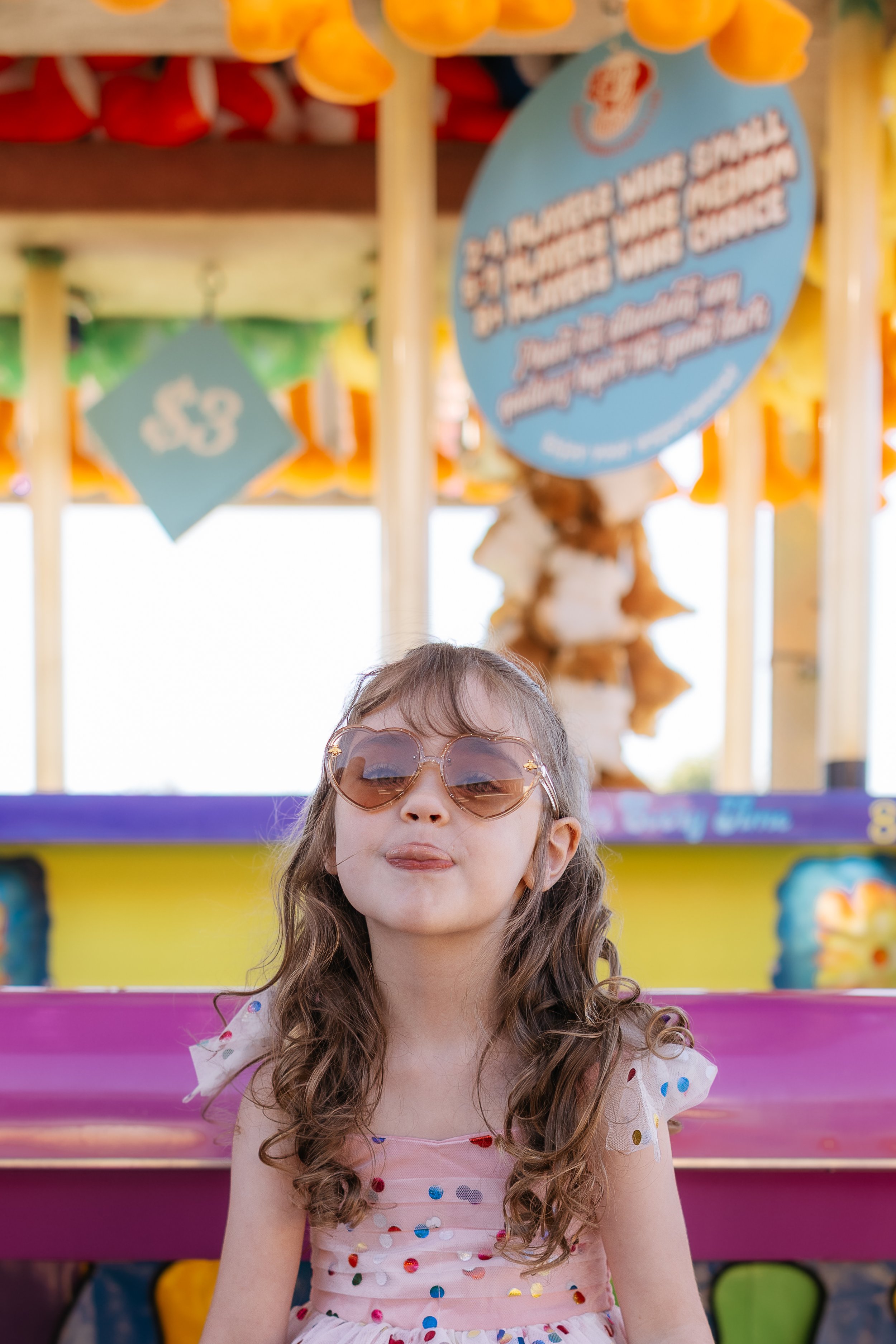 a young girl at the fair sticking her tongue out during a ottawa mini session photoshoot