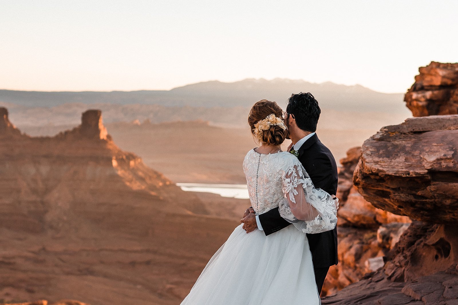 Couple looking across desert elopement 