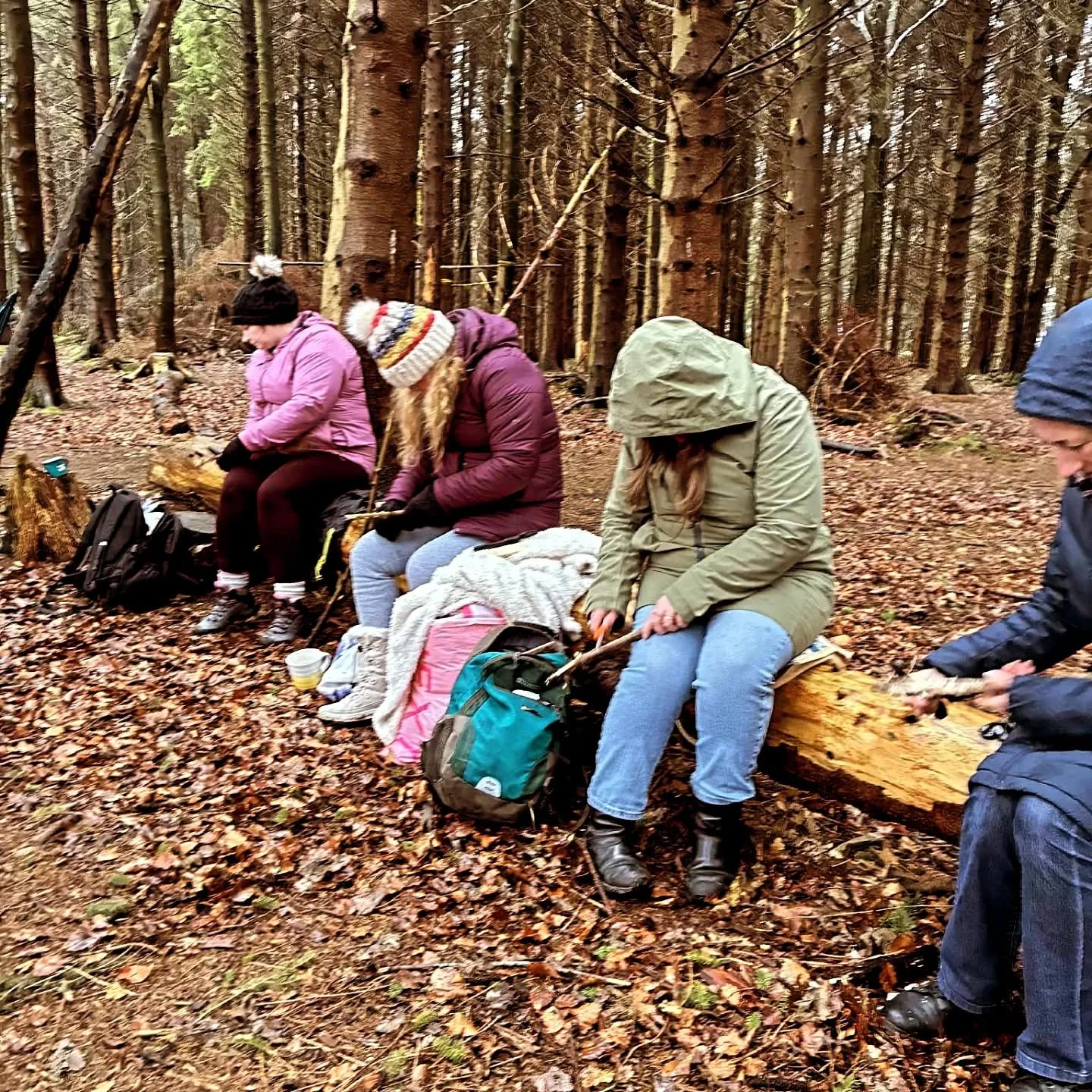 lush green forest floor with 3 ladies and an instructor in the background
