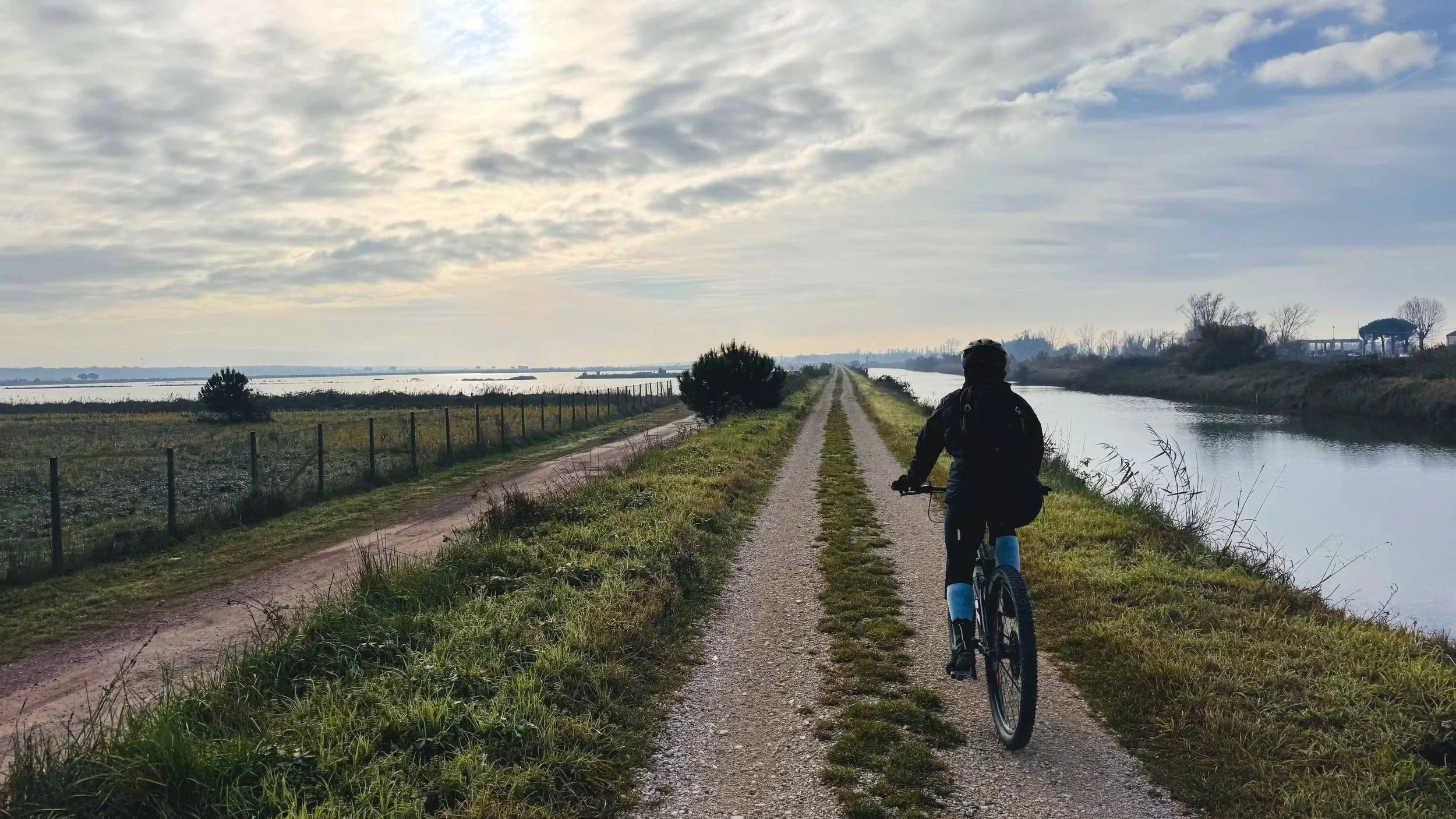Comacchio Cyclist along Gravel Flat Road next to the Canals