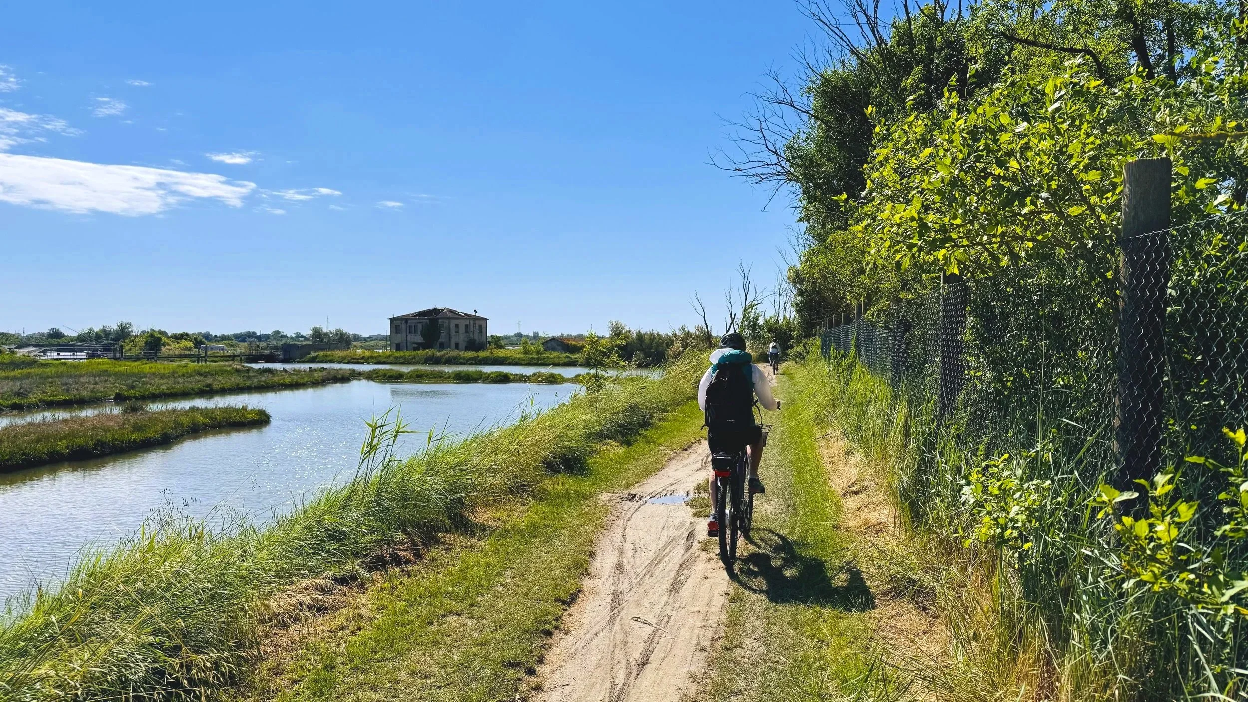 Comacchio Cyclist Along Lagoons near Bettolino delle Foce