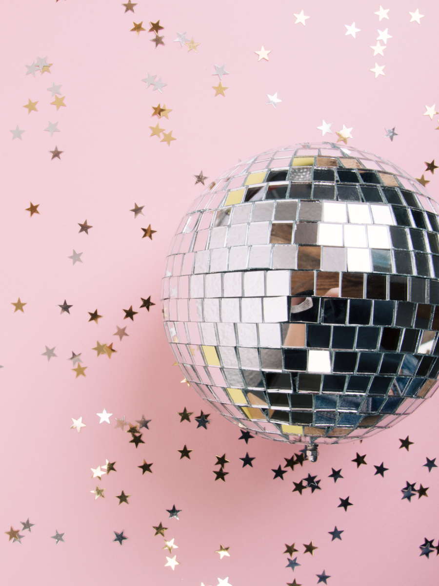 Disco ball on pink background, star confetti