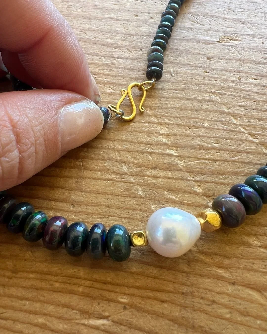 Beautiful rare black opal necklace, with 18 karat gold accents and Baroque pearl. #Fine #jewelry #mothersday #creation